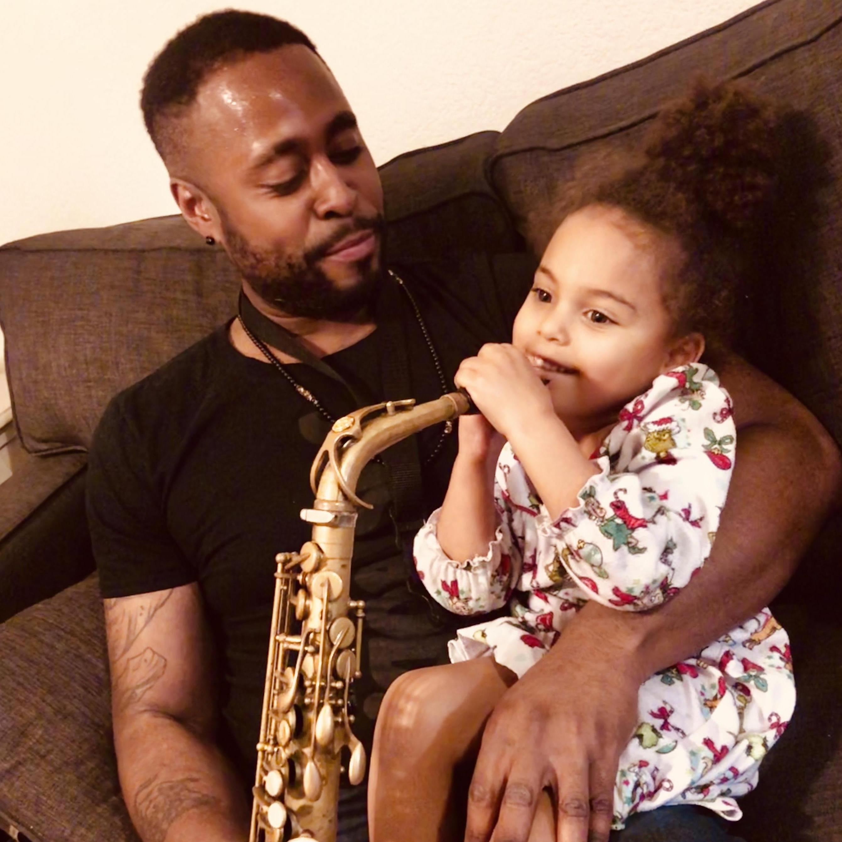 Like Mommy, SJ loves when Daddy plays his sax!