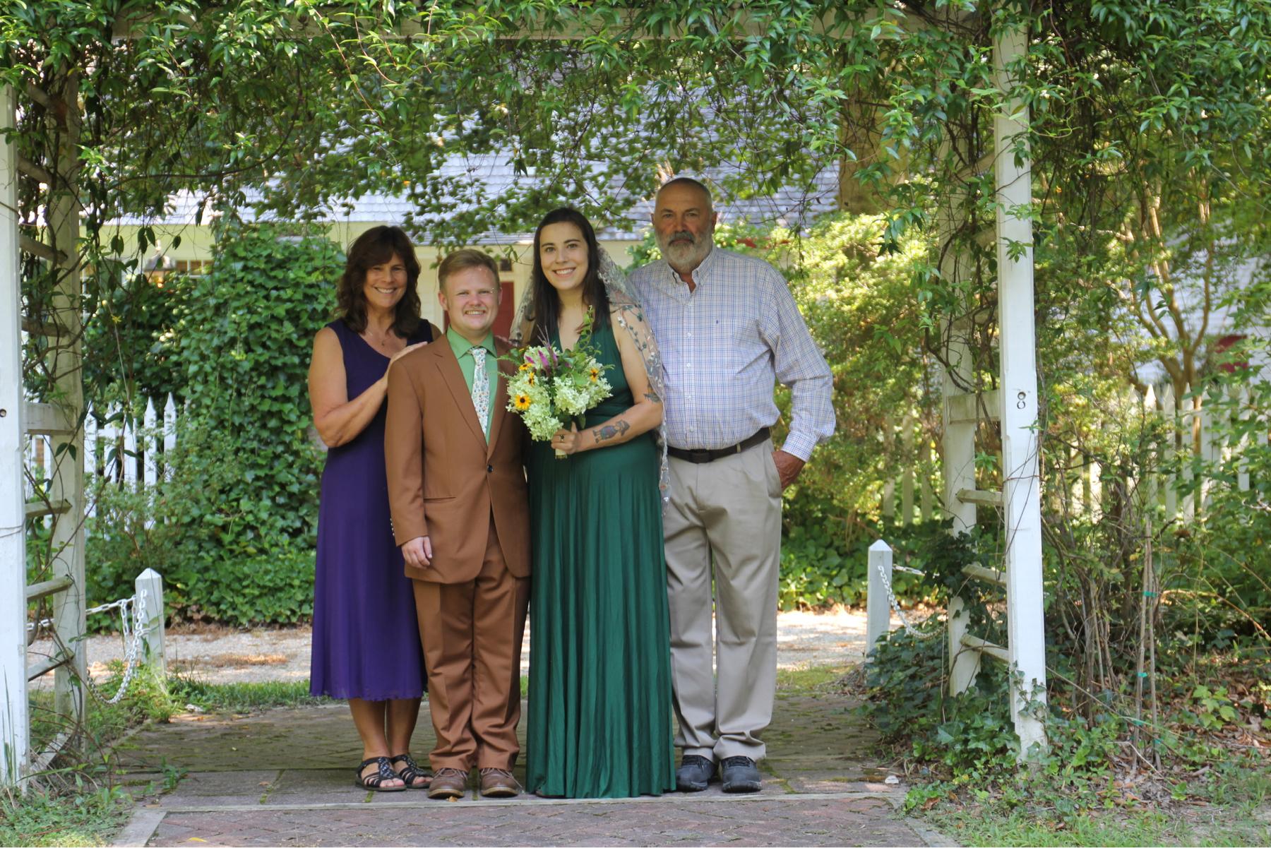 Eliot and Natalie with Natalie’s parents, Mike and Lisa, on the wedding day!