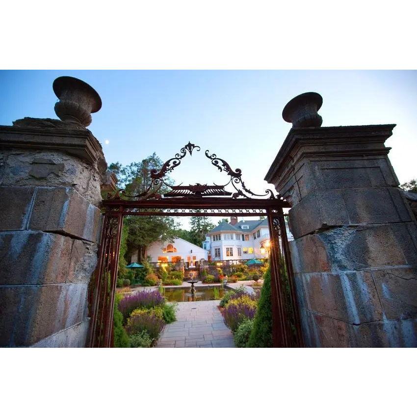 The historic iron gates at the entrance to the Harding Allen Estate garden stand as a majestic portal, ushering visitors into a realm of timeless elegance and lush tranquility.