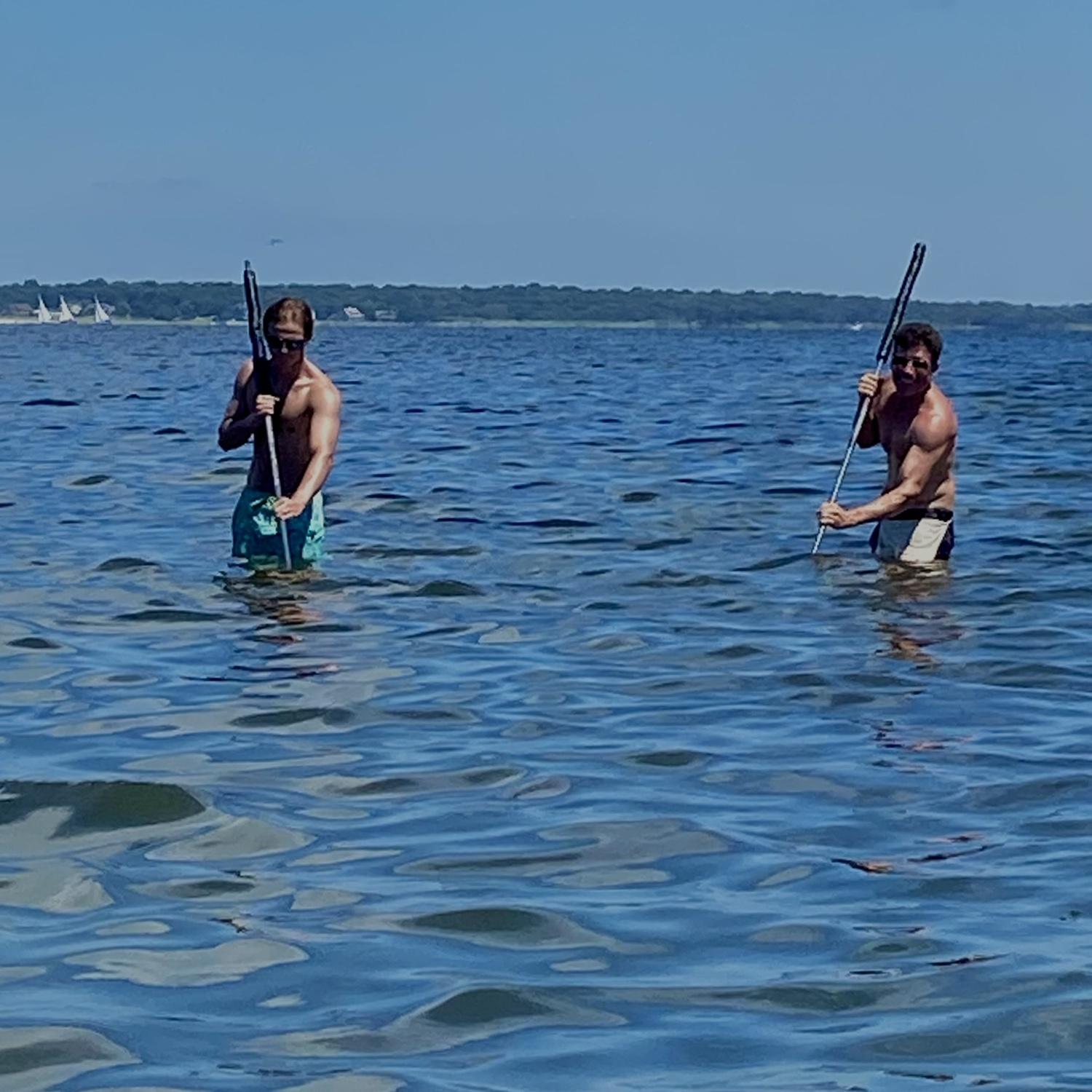 Dad teaching Nick how to clam