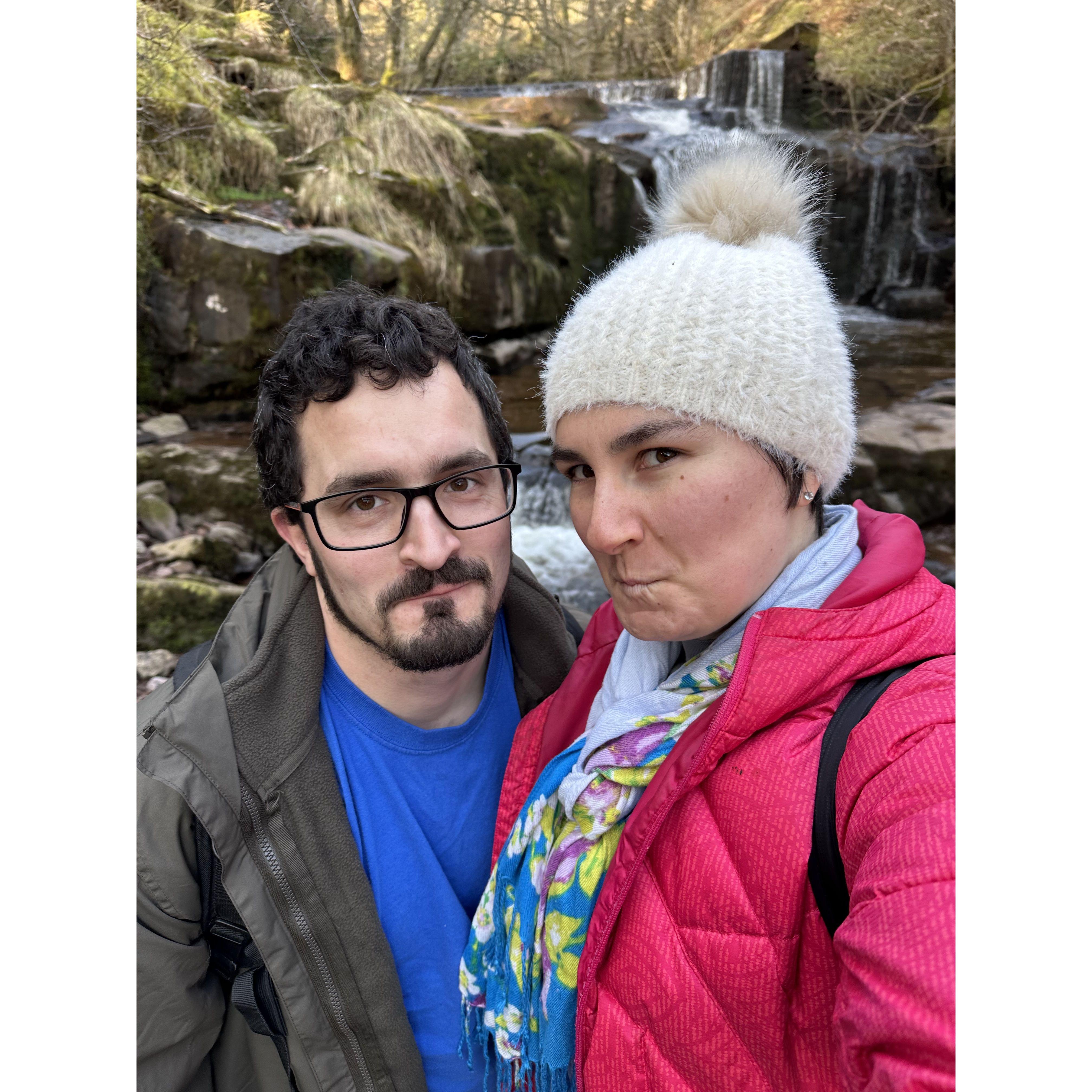 Trying to keep a straight face for the hilarity of it in Wales, next to one waterfall of a solid half a dozen or more on the same trail!