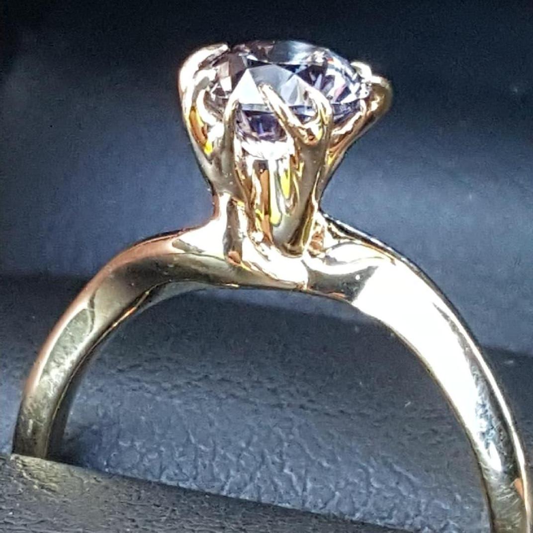 Chase designed the band and setting and worked with the jeweler to create this custom ring. The band is two deer heads with antlers holding the stone. Can you see it? It is elegant outdoorsy.