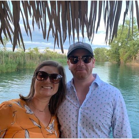 Lindsey and Brendan on a Tiki boat in the summer.