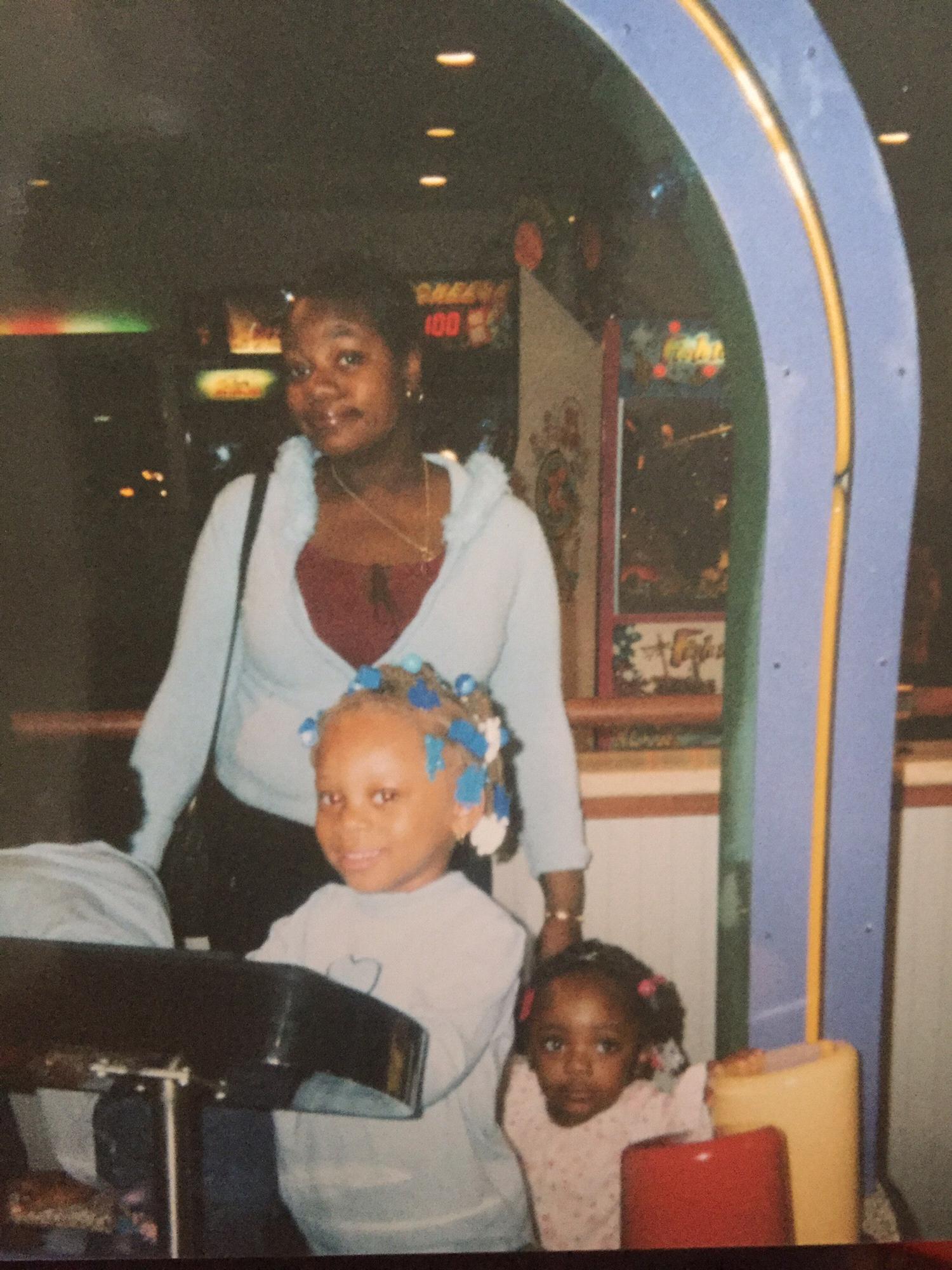 Kyla on the keys, aunt Lakeia in the back and her sister Aria on the right at Chuck E Cheese