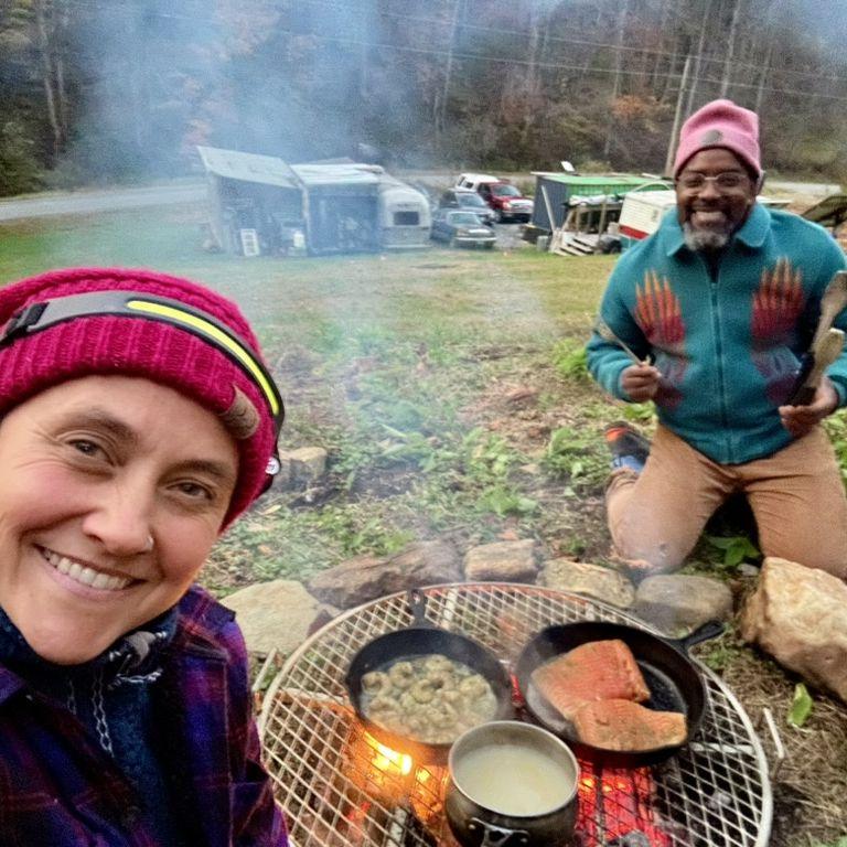 Cooking over fire at our future home site, with our current home site there behind us.