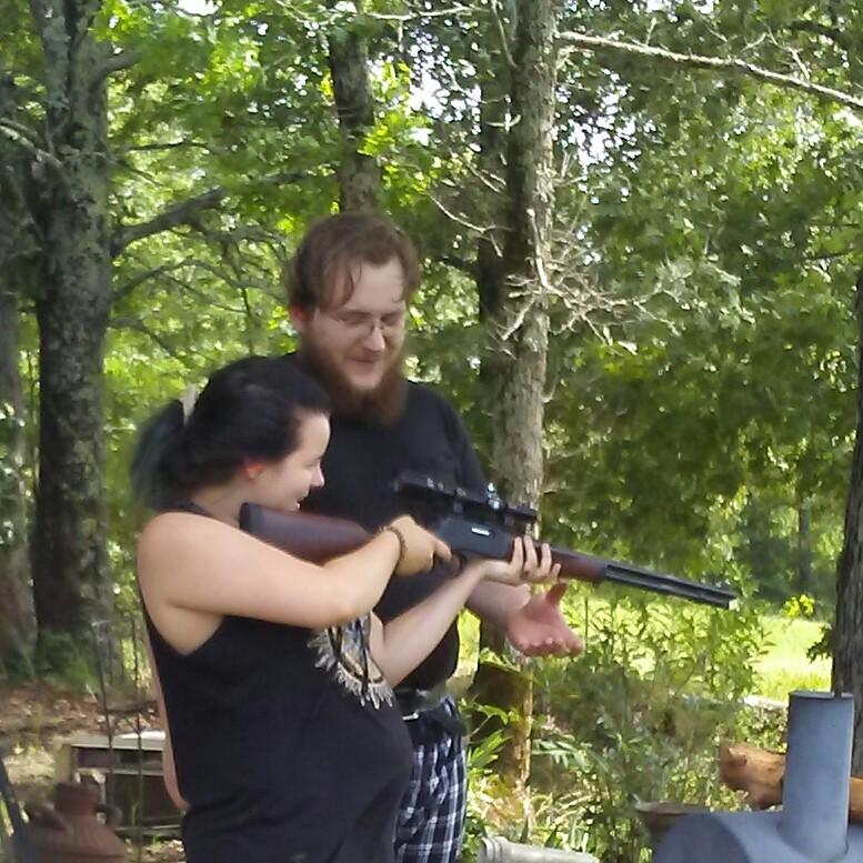 Mason teaching Kaylee to shoot a gun