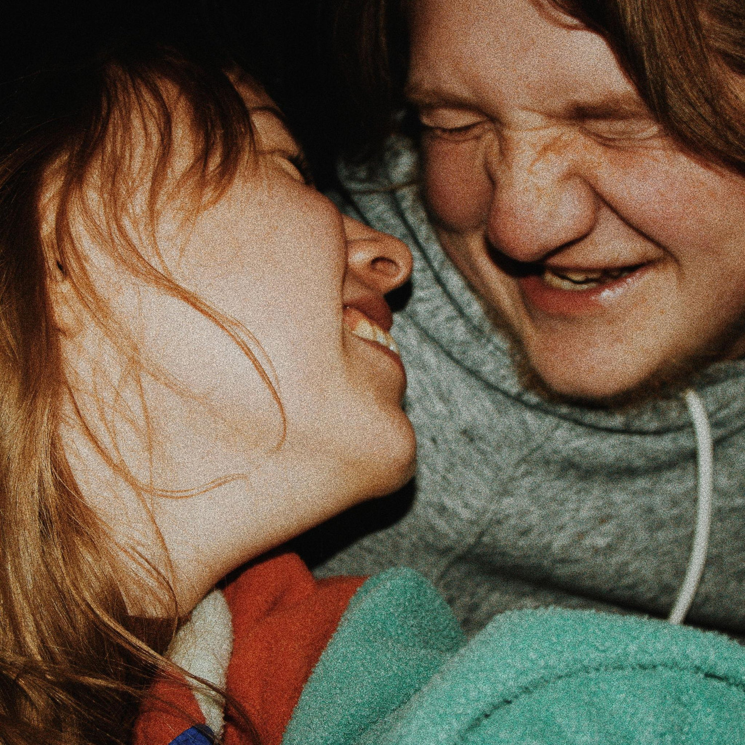 Us our senior year of highschool, laughing while trying to take a selfie on a professional camera