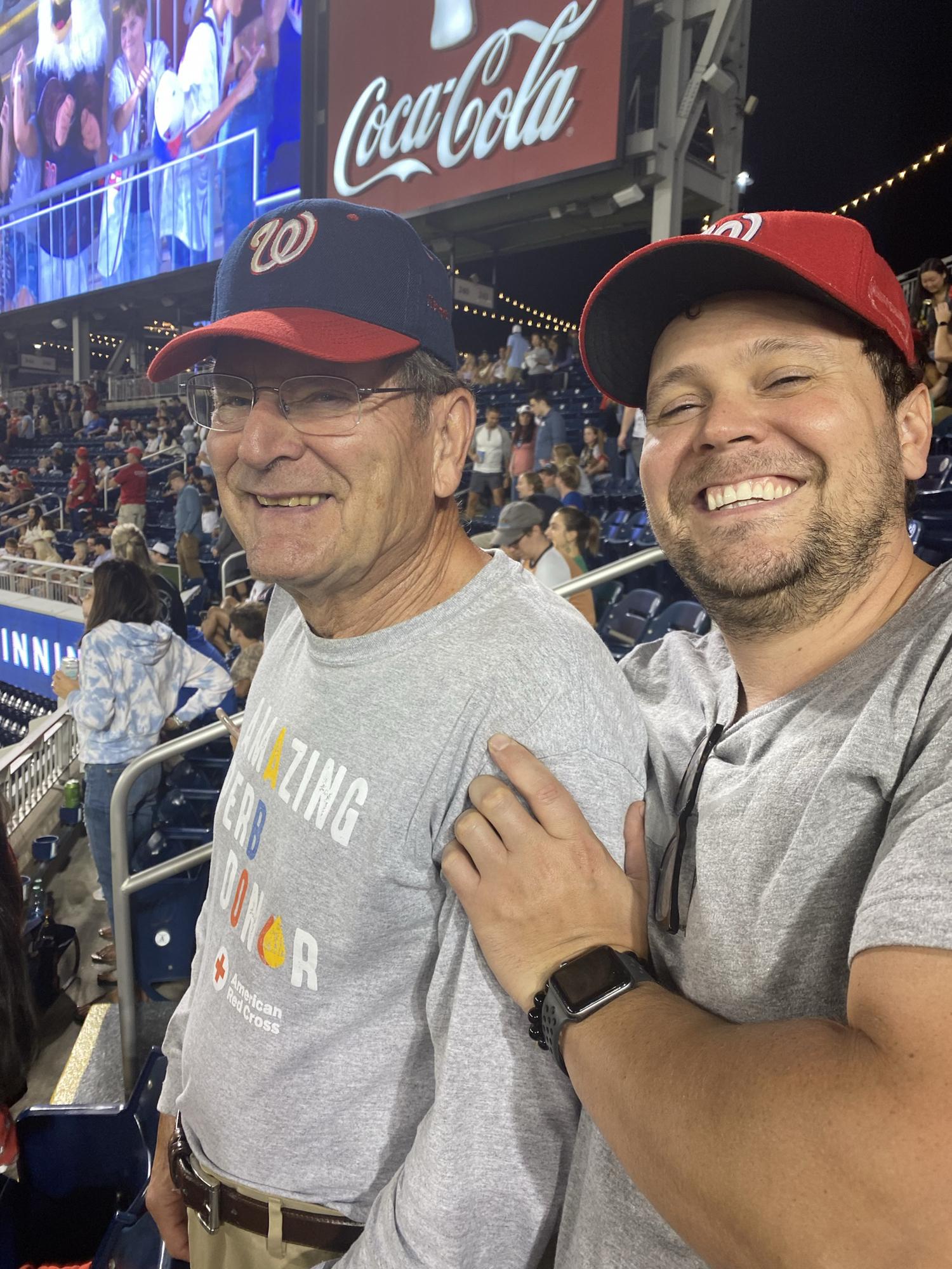 Luke with his dad at a Nationals baseball game