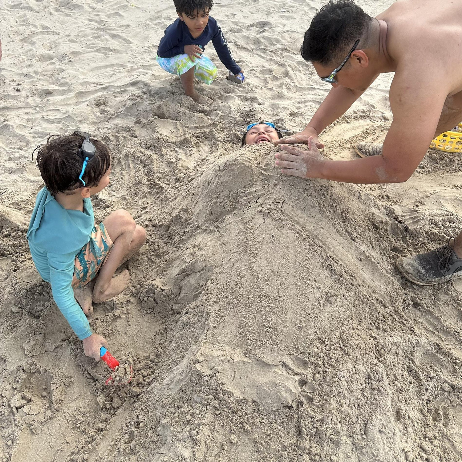 6/21/25- Beach day with best friends! Nothing says friendship like burying your buddy in sand! The boys had a blast, and Sam was a good sport.