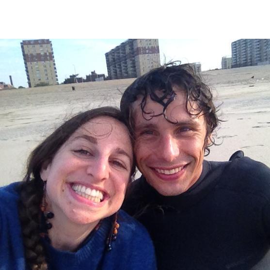 Our first photo together: pre-work surf outing in the Rockaways. Dana cozied up on the beach in Ian's sweater while Ian got barreled.