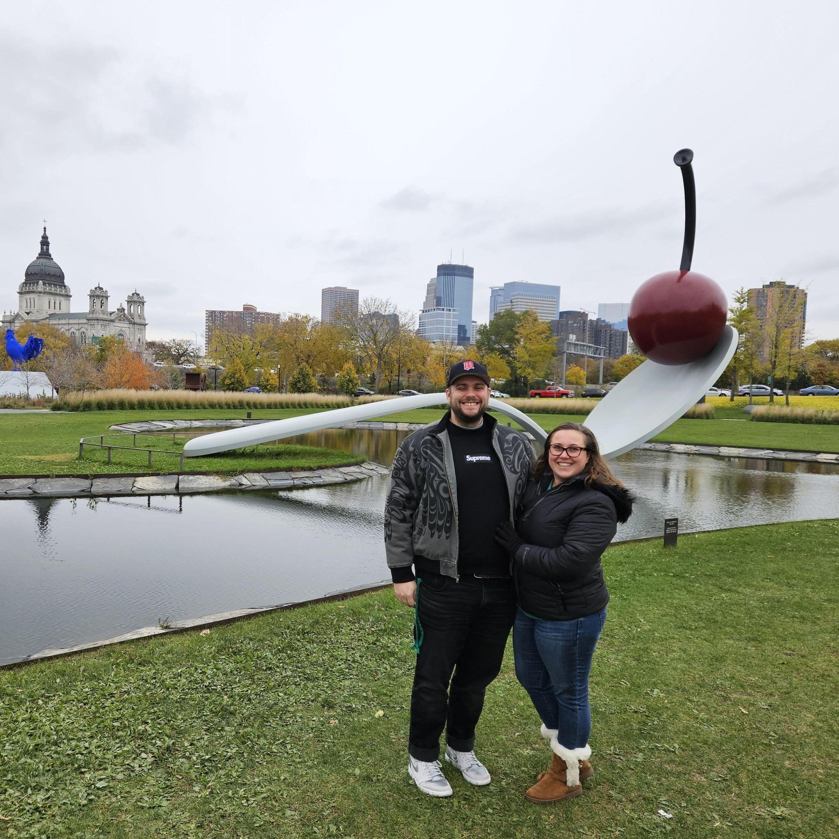 Spoonbridge and Cherry! A Classic!

Alt Text: Maeghan and Keiran bundled up on a cool fall day in front of the Cherry and Spoon sculpture