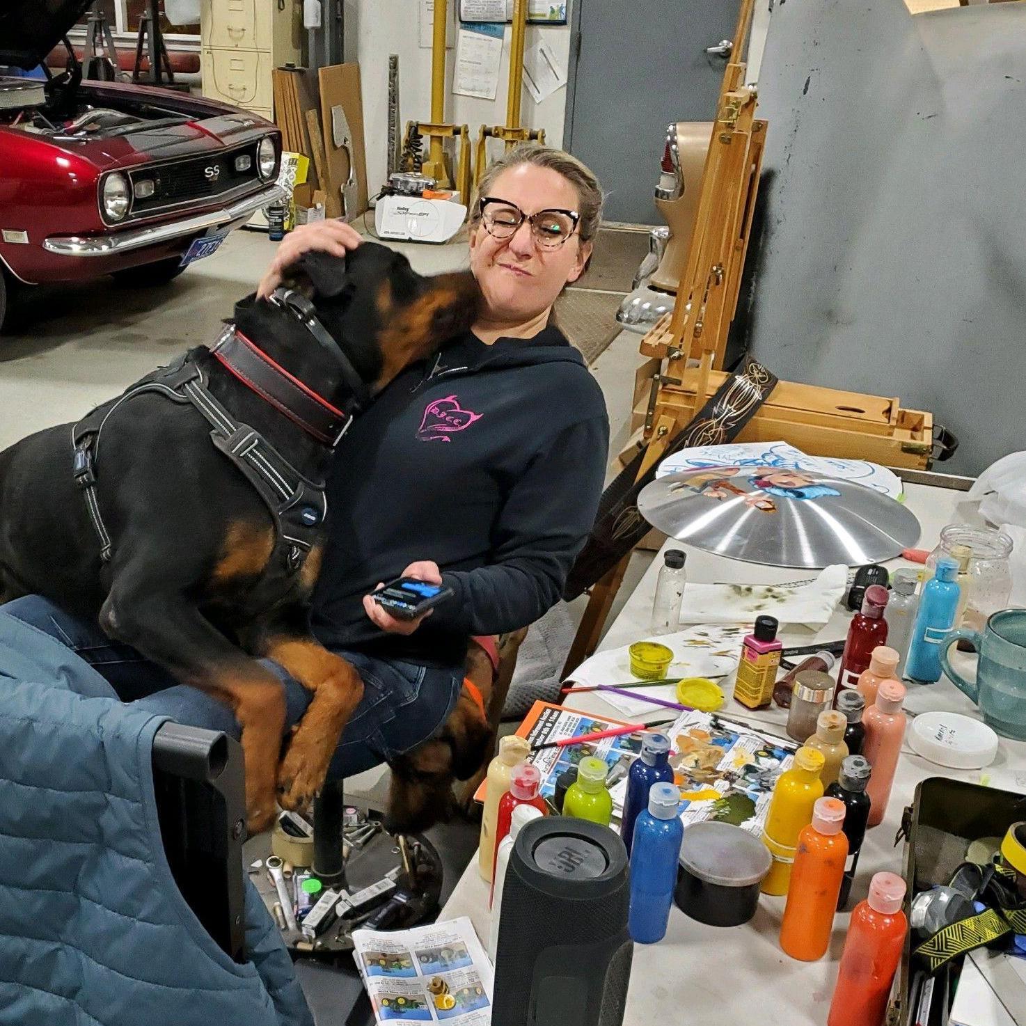 Novak helping Kendra paint her panel for Brush Off, 2022