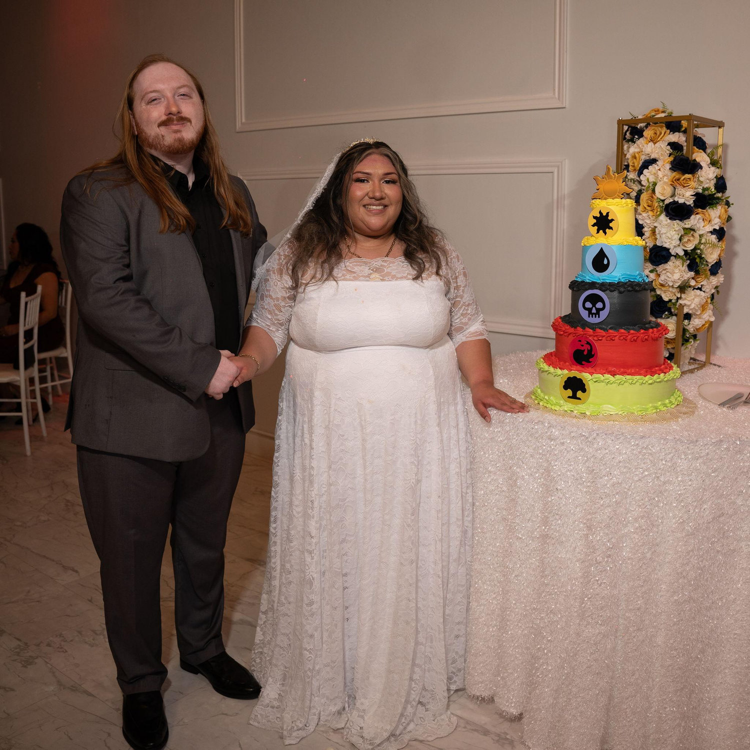 Bride and groom with our Magic: The Gathering themed wedding cake.