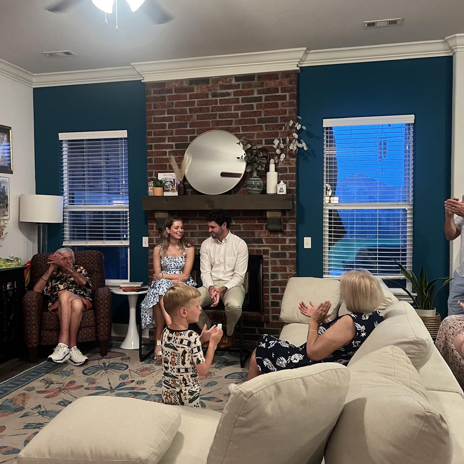 7/18/2025- Photo of Merrick sharing the proposal story at our engagement party at his sisters house in Springdale, Arkansas.
