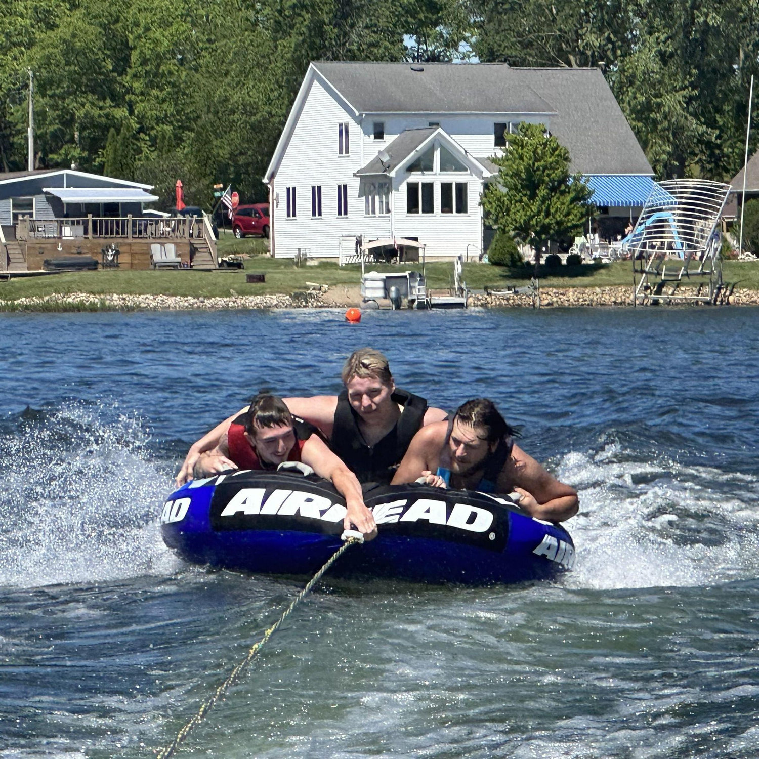 Nick, Athen, and Ethan, tubing at the lake