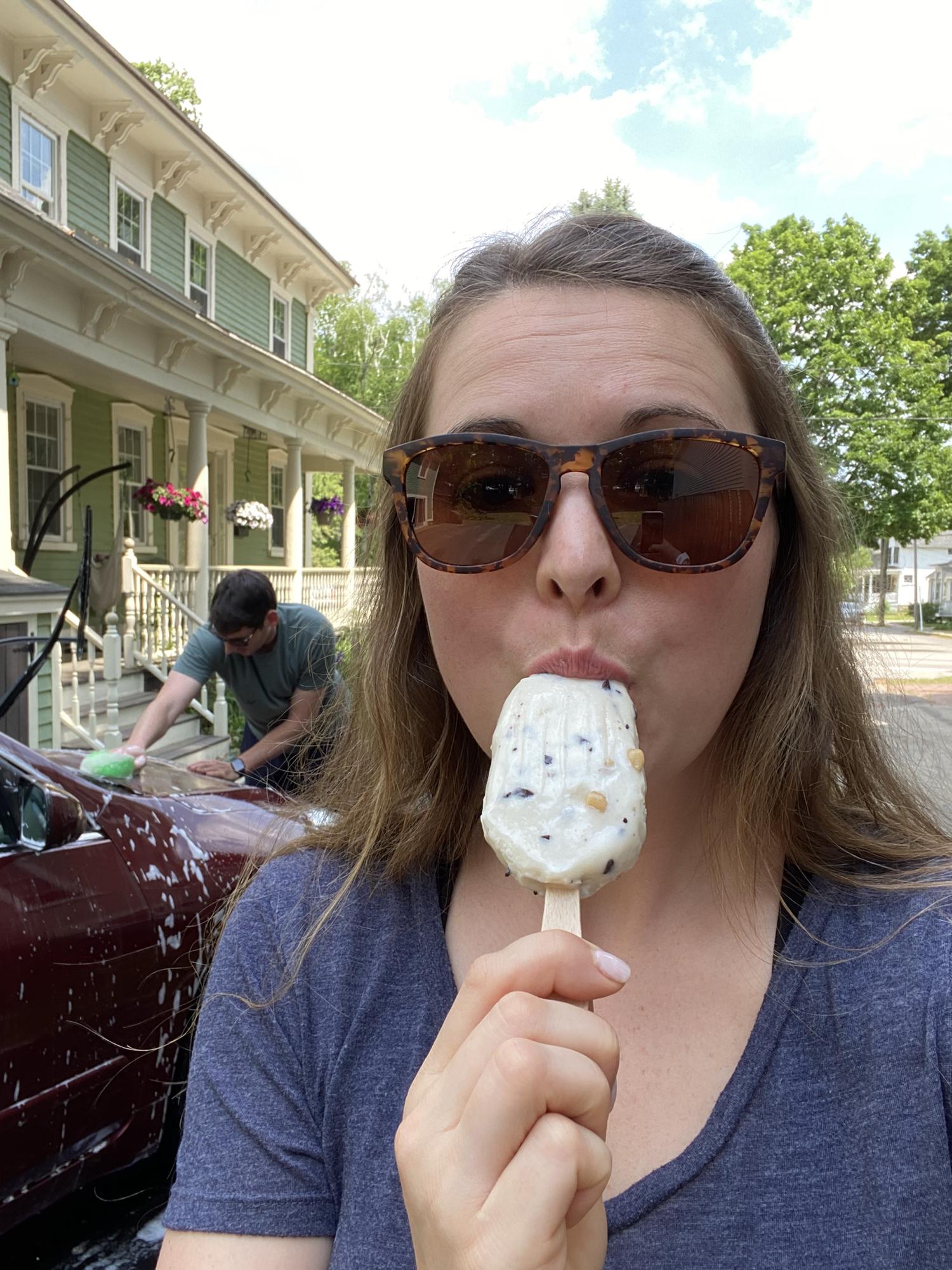 Kristina enjoying a popsicle on a warm summer day while Marc’s hard at work