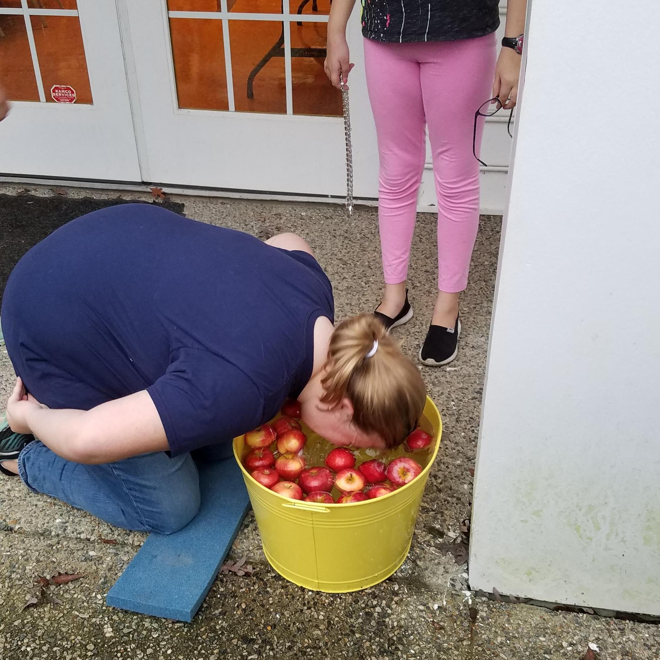 Caroline showing off her apple catching skills at Oktoberfest neighborhood party.