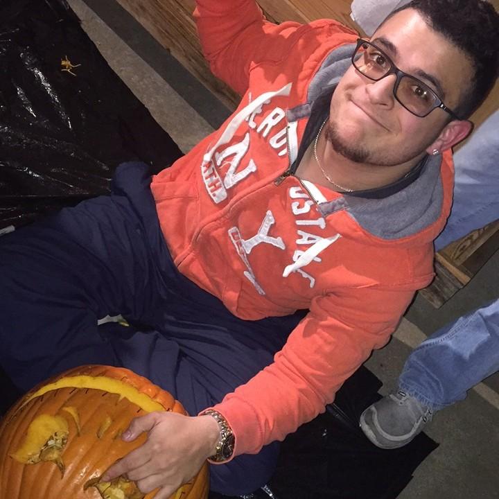 Michael carving out pumpkin