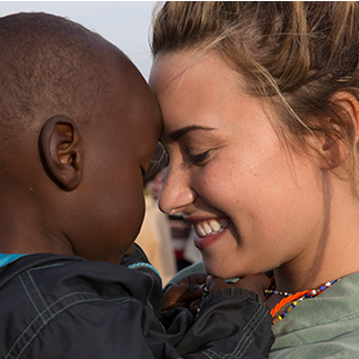 Alex saying goodbye to Absko, a child she'd bonded with before she leaves for home.