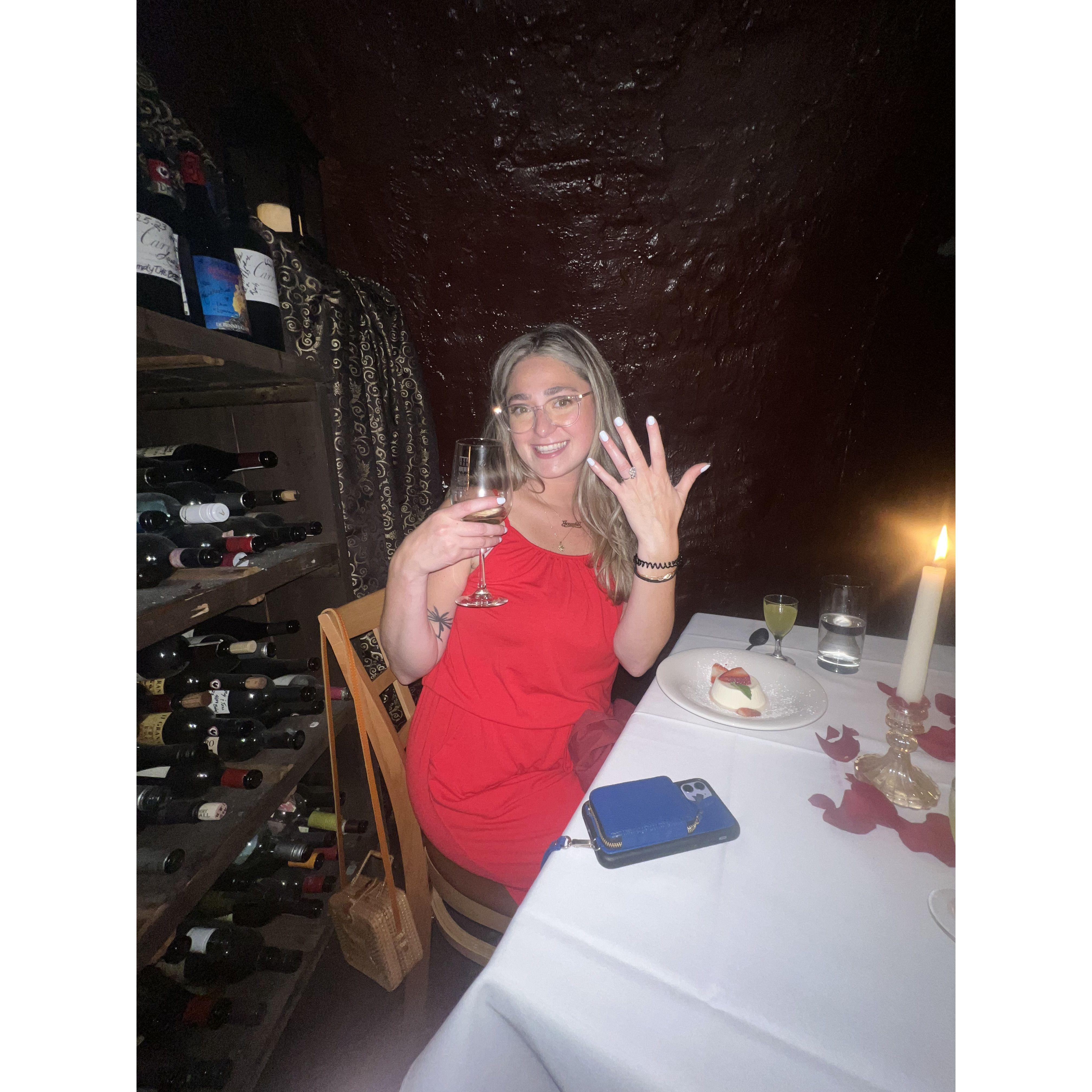 Jamie flashing her ring after Bret proposed in the Wine Cellar at Bistro Romano!