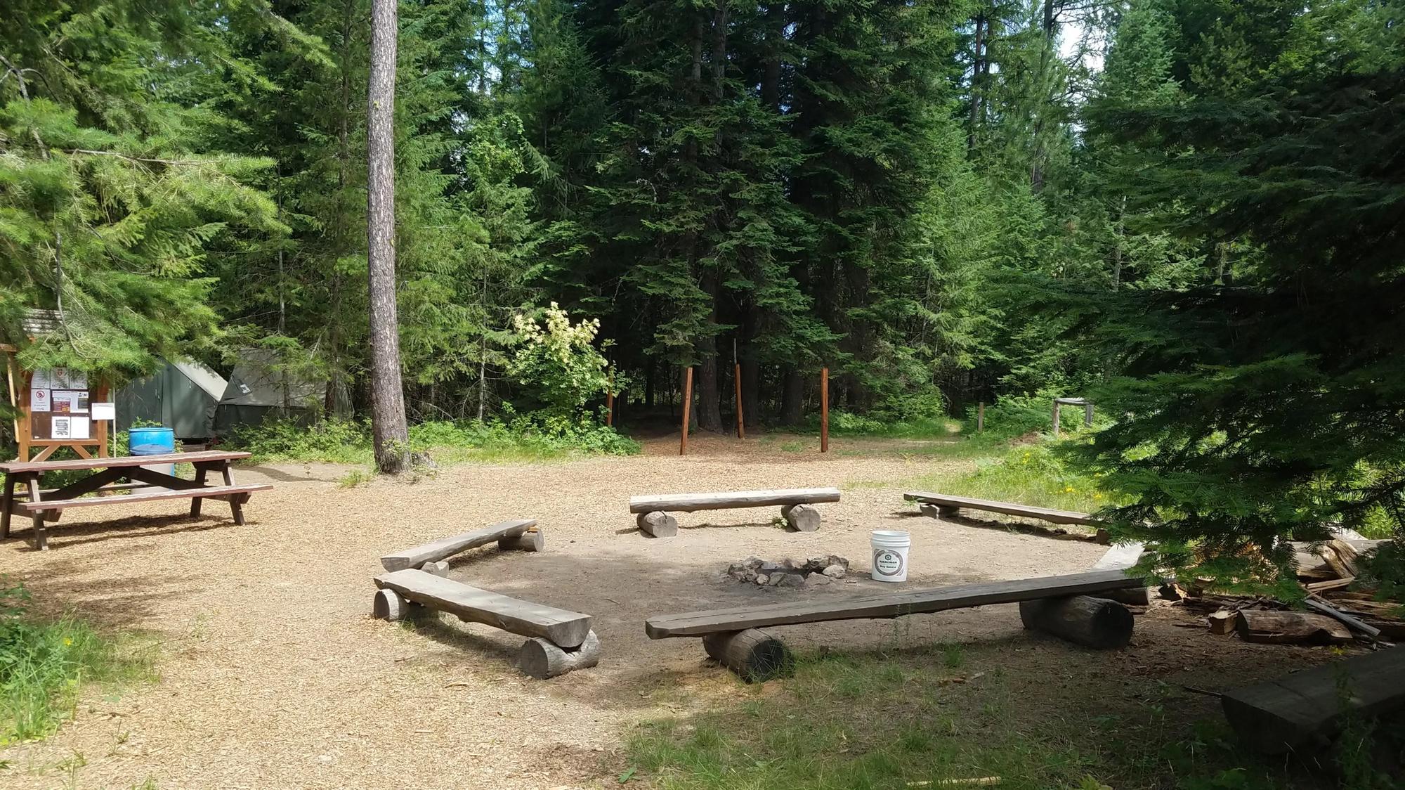 One of the fire pits located in the middle of a cluster of ten platform tents.
