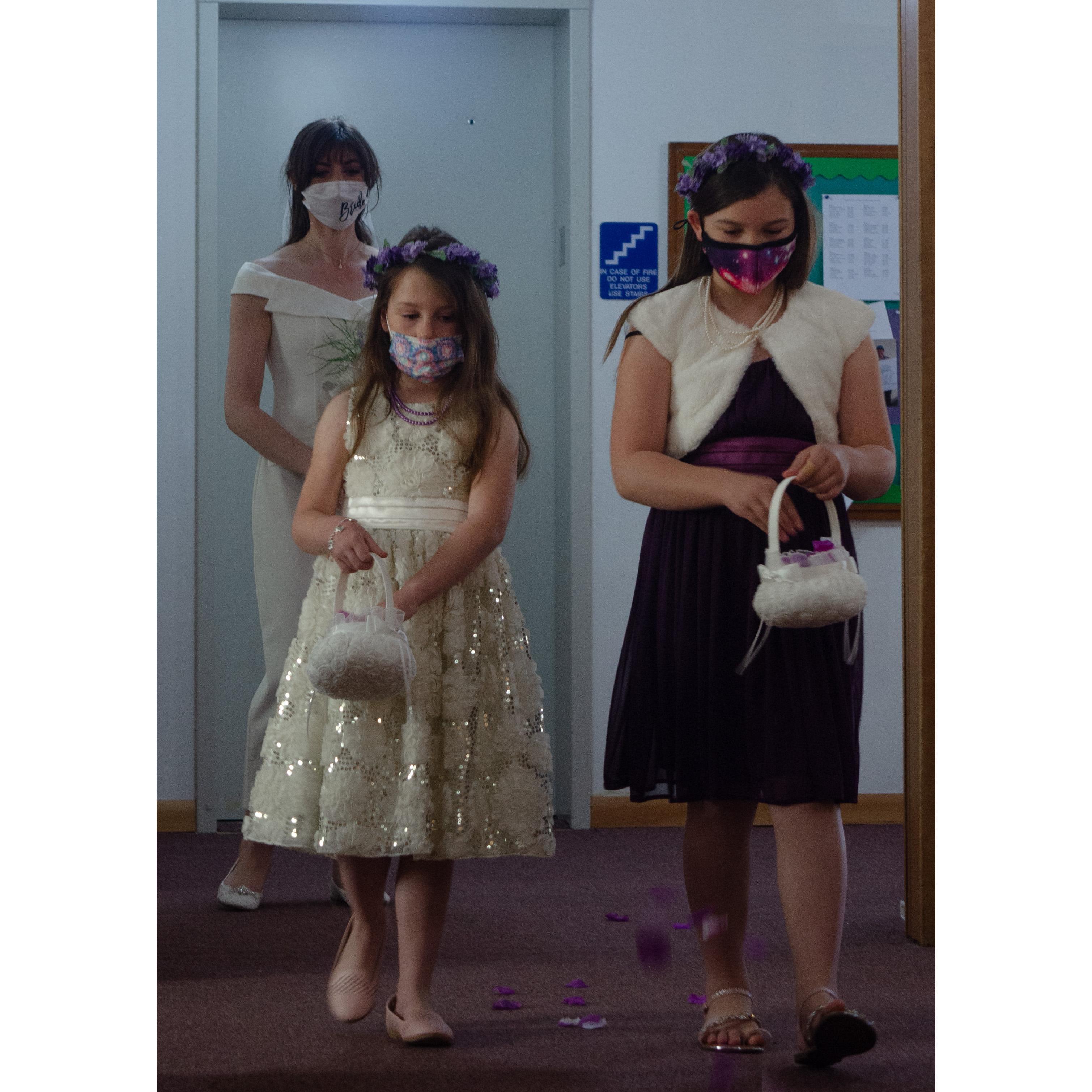 The Flower Girls, Lizzy Knapp (left) and Natalie Knapp (right), beginning their walk down the isle.