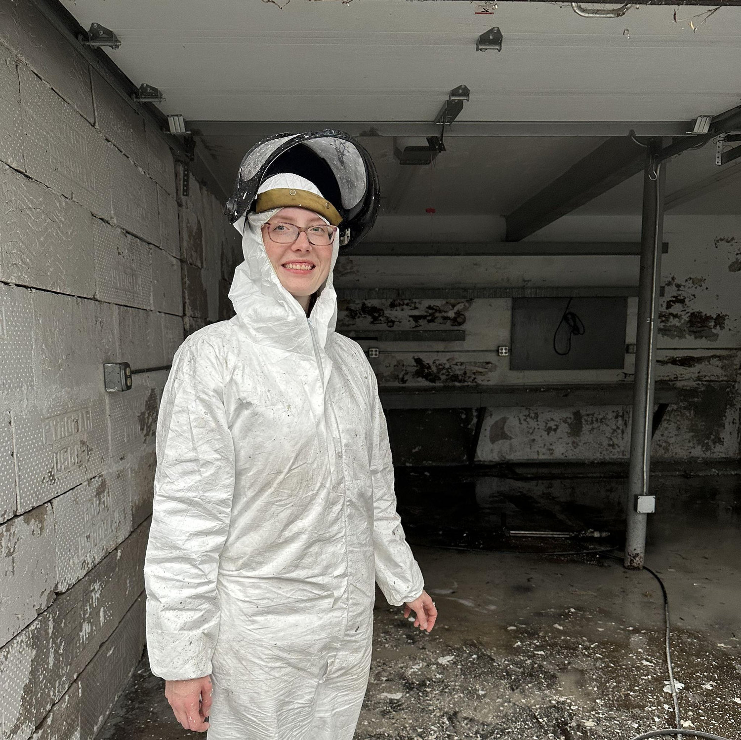Zach took this photo of Sierra right after they moved into the house. First order of business - power wash the moldy garage! (Thank you to Fred for loaning us the power-washer.)