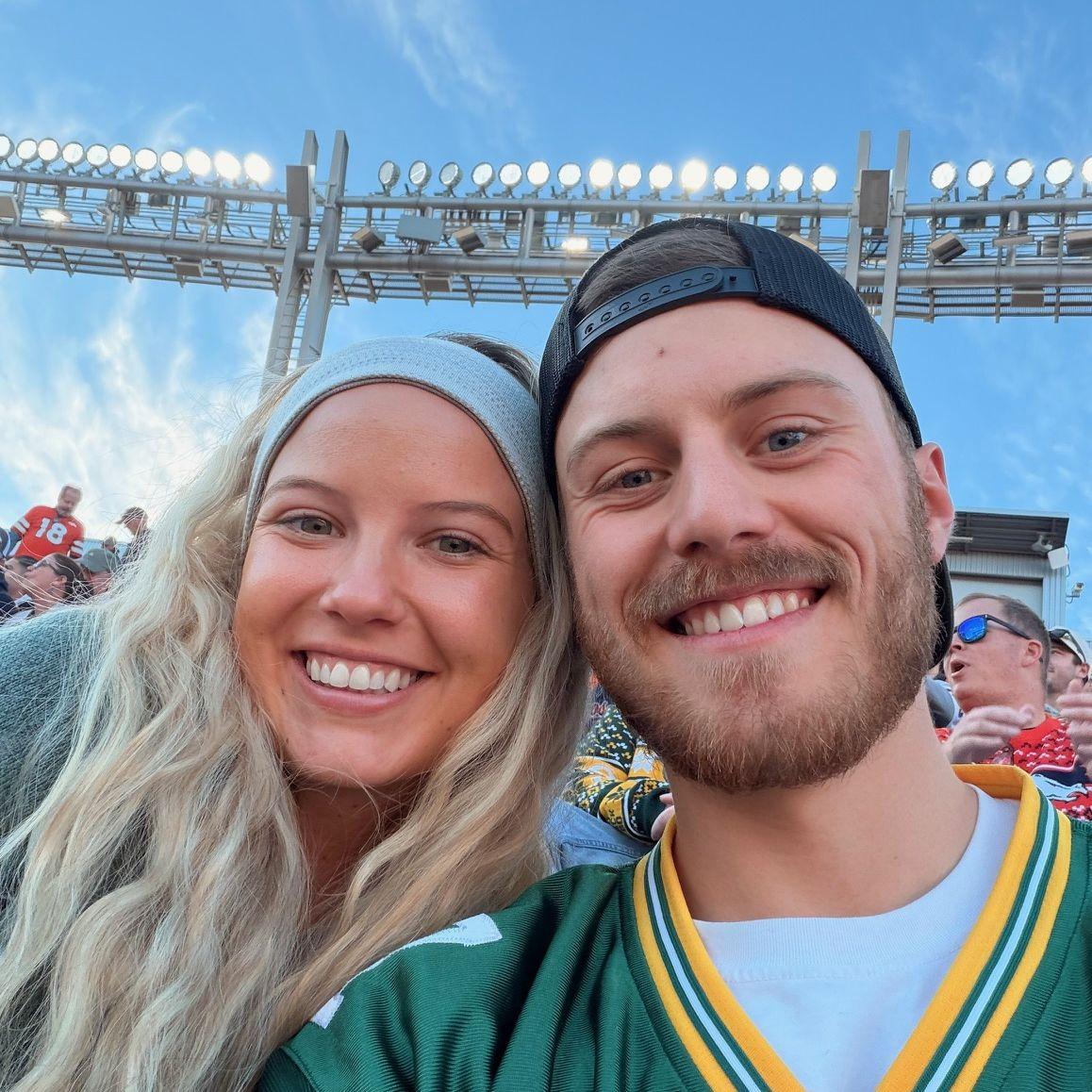 Basia and Logan at their first regular season Packers game in Denver. Basia is obligated to be a Packers fan immediately after the wedding. (2025)