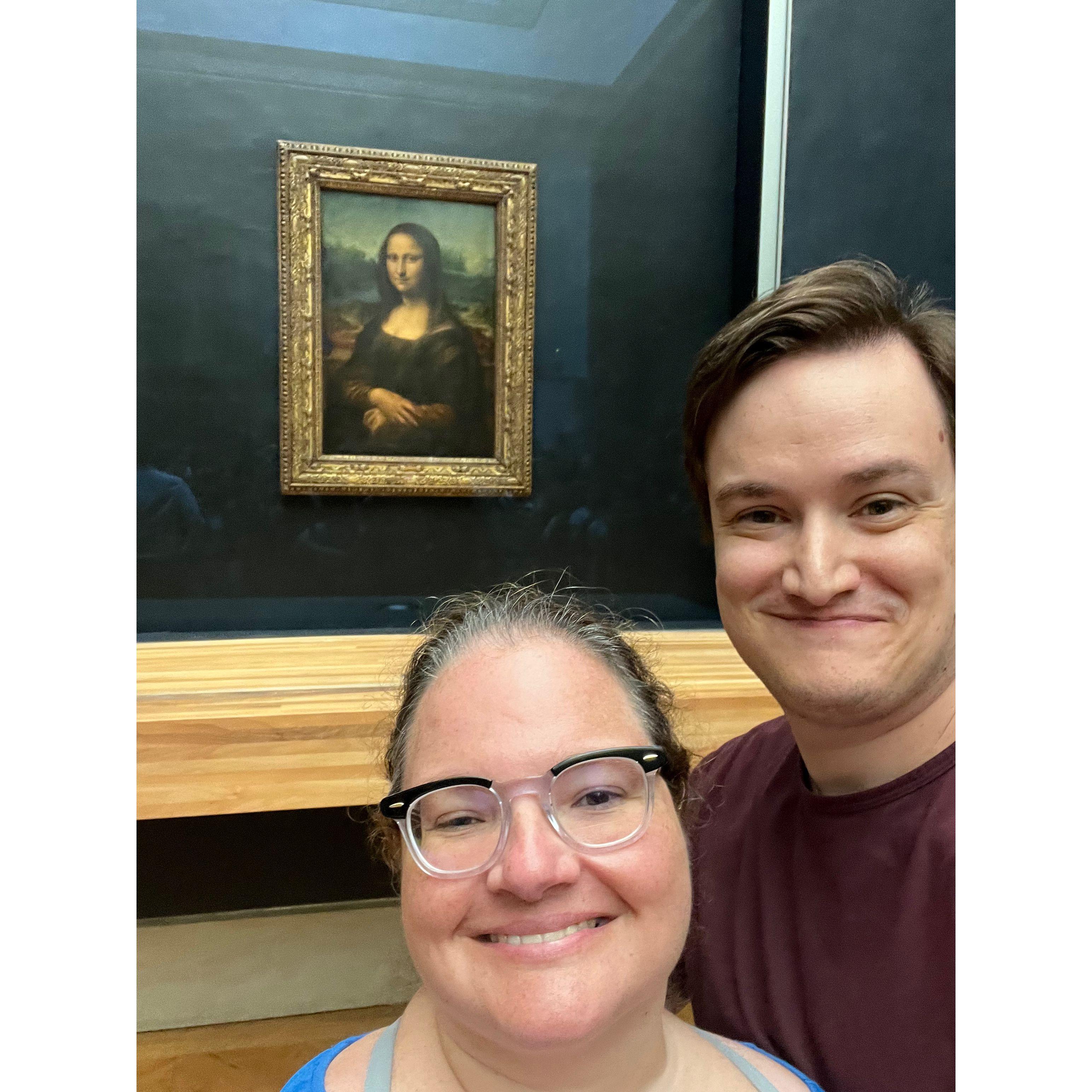 Selfie with the Mona Lisa behind them at the Louvre
