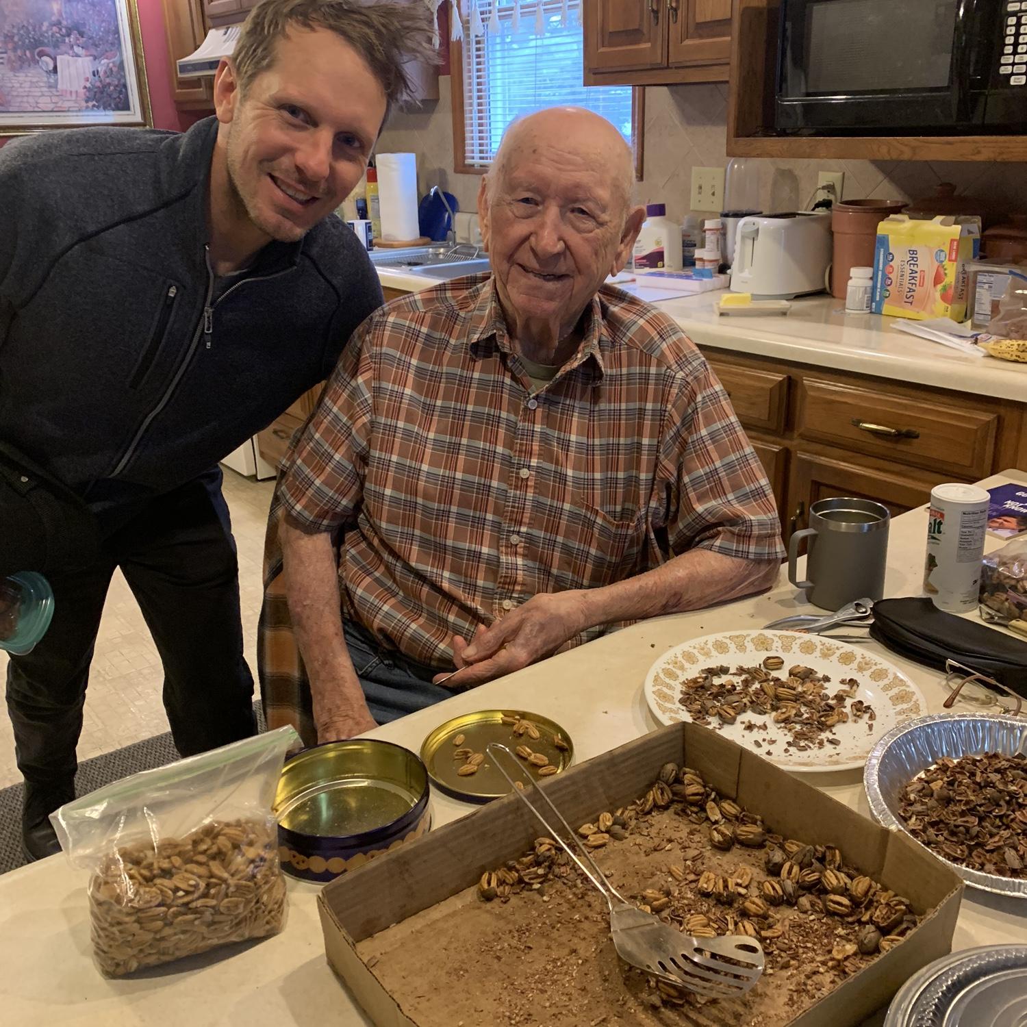 Tyler with his Grandpa Frank (who has his pecan shelling set-up in front of him in this photo)
