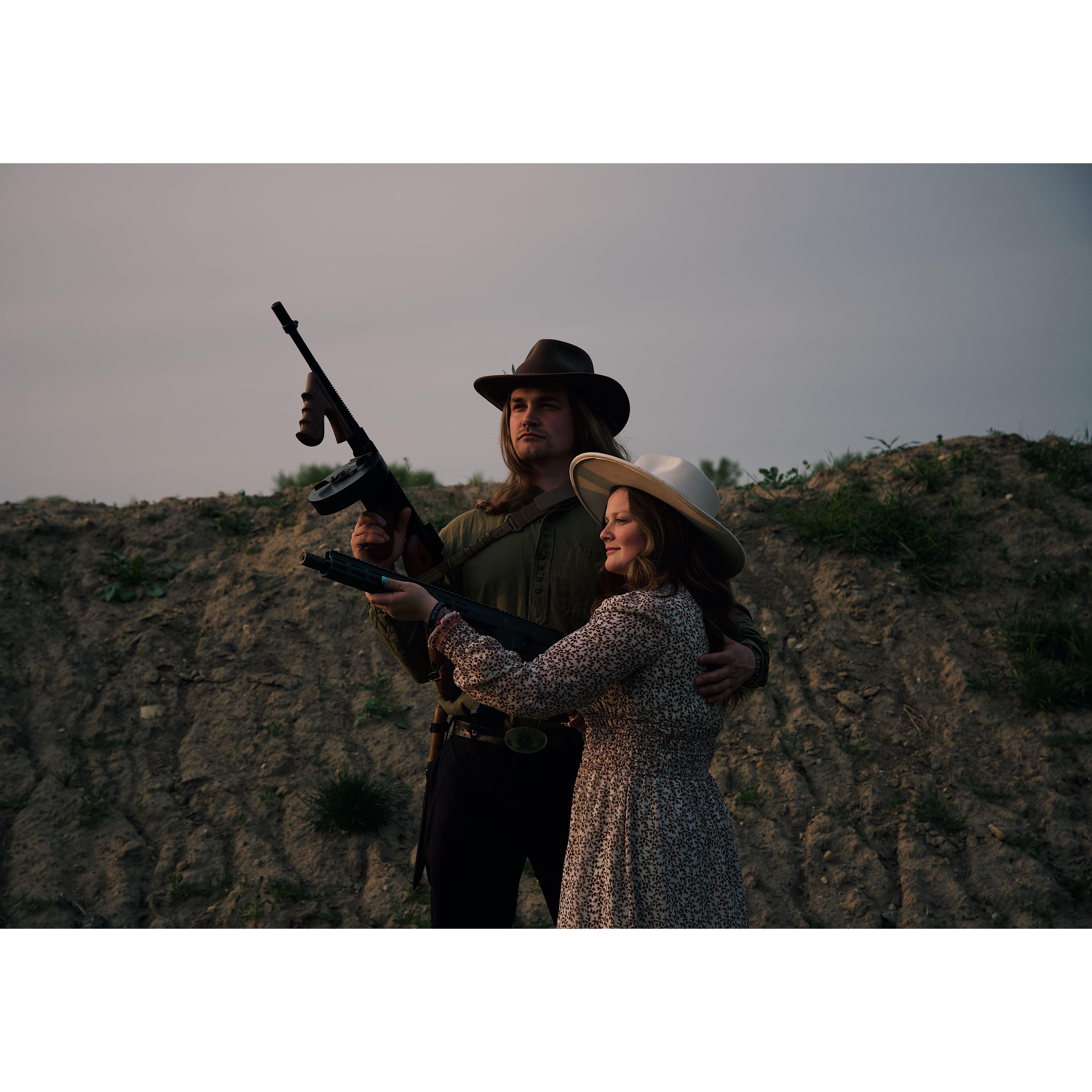 5/21/2023 Height of luxury, a man holding a gun and his girl.  Photo Credit: Hannah Kuhn