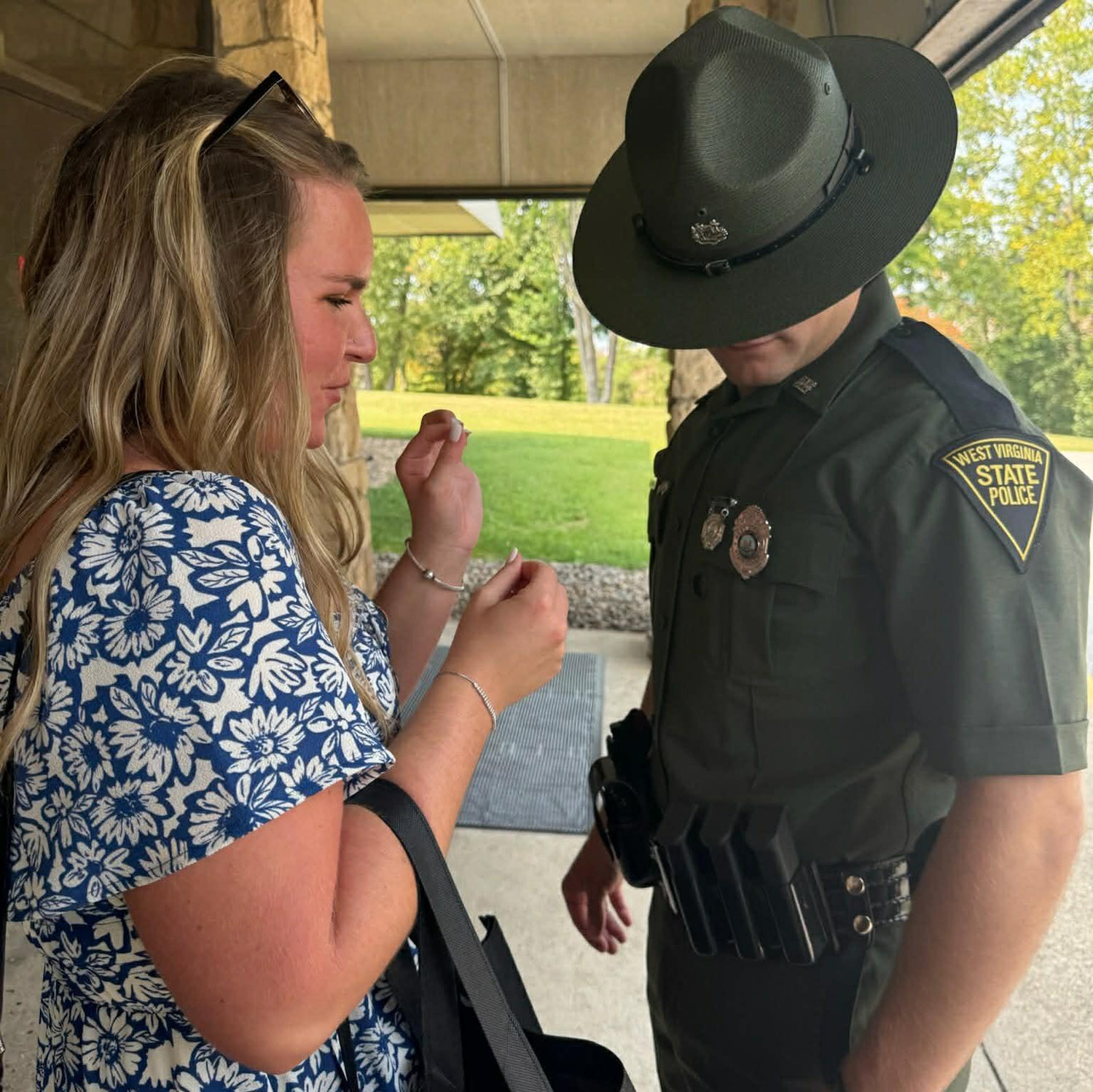 Taylor putting Dustin's badge on for the first time