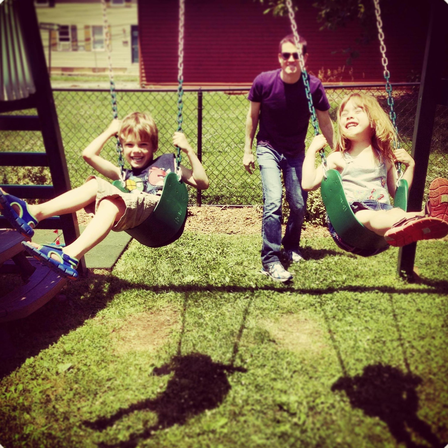 Uncle David pushing Gabriel and Bethany on the swings.  Chambersburg, PA.
