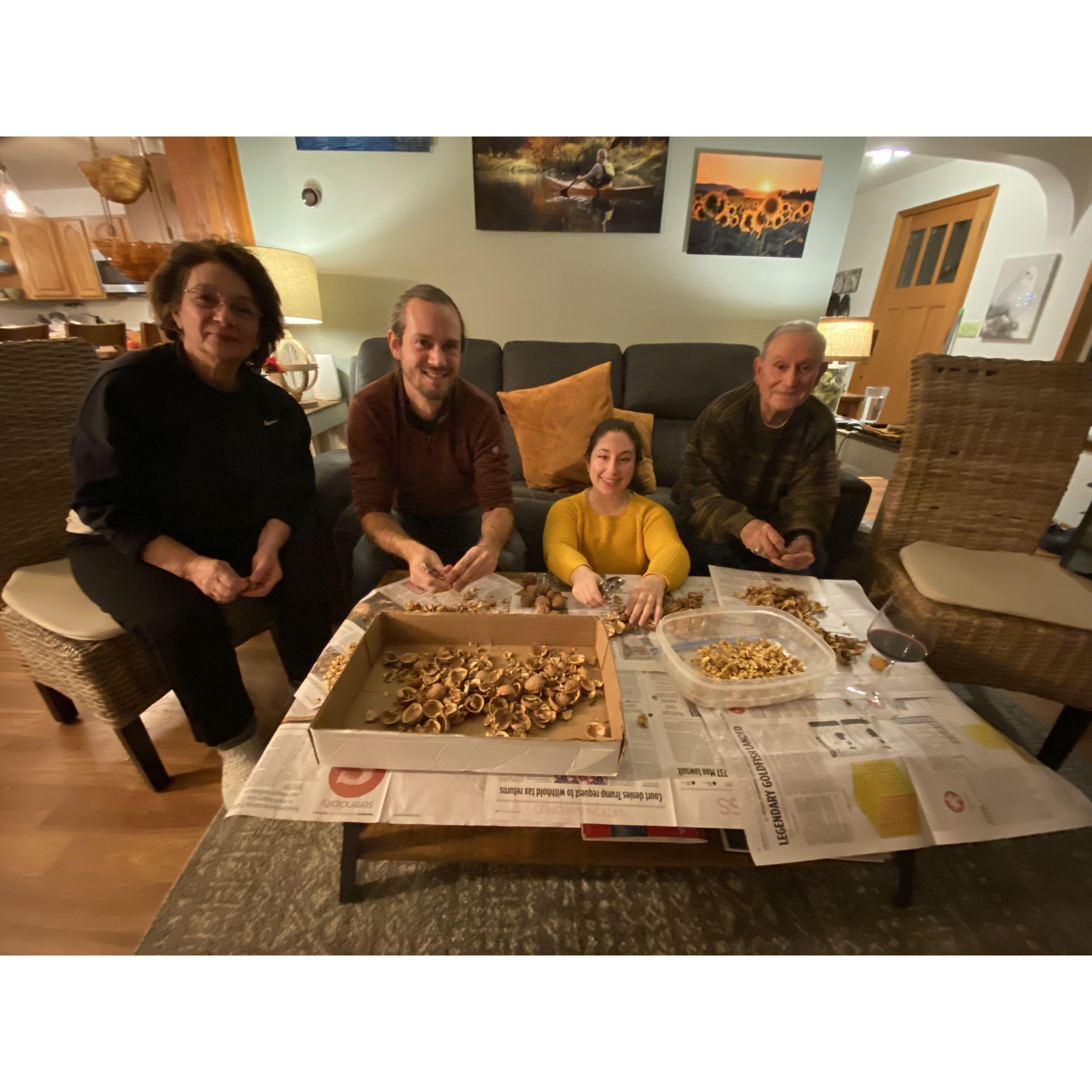 More cracking walnuts with Sylvana's parents Maria Elena and Alvaro; Thanksgiving 2022. Sylvana is very smol.
