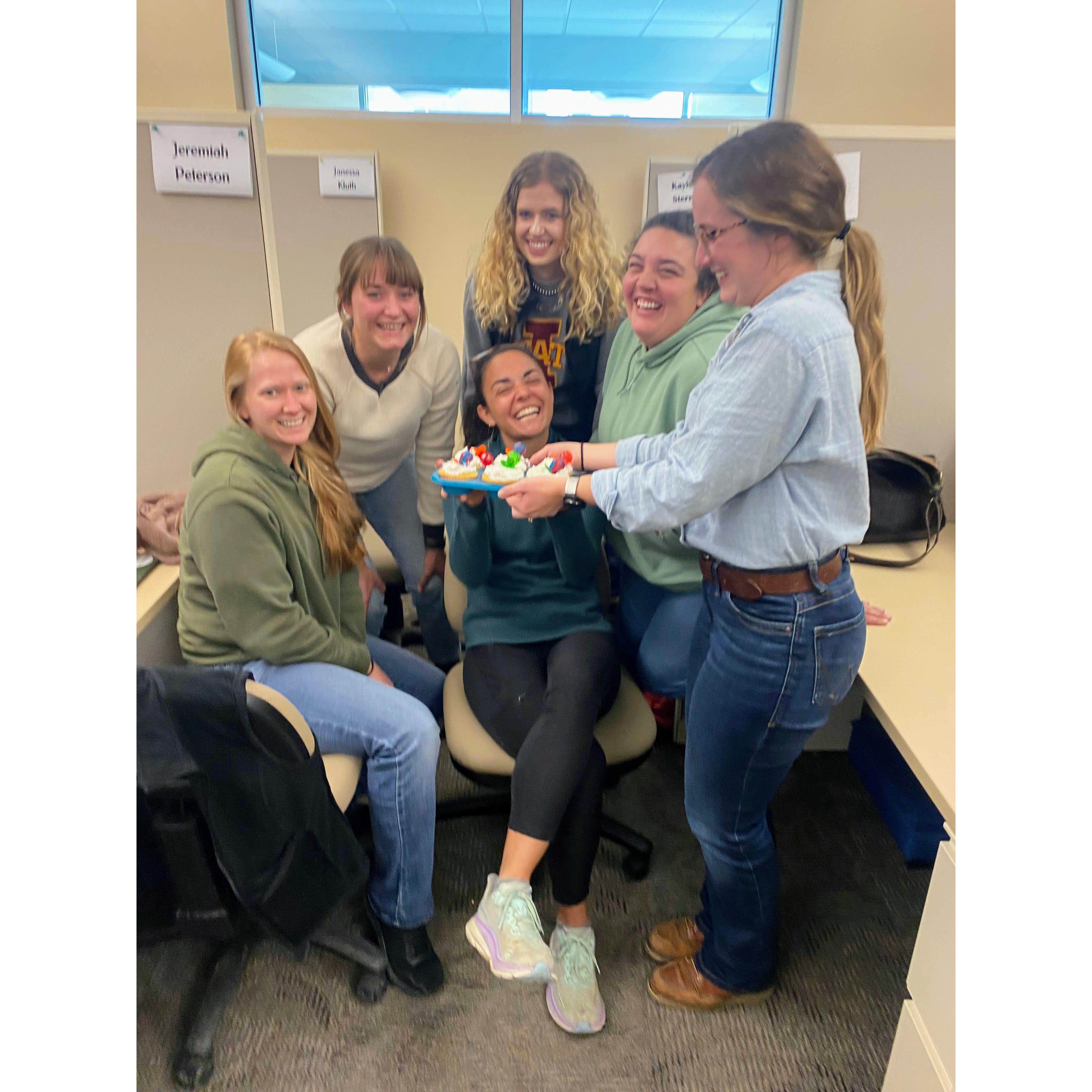 Jackie's graduate student office surprising her with ring pop cupcakes after the engagement