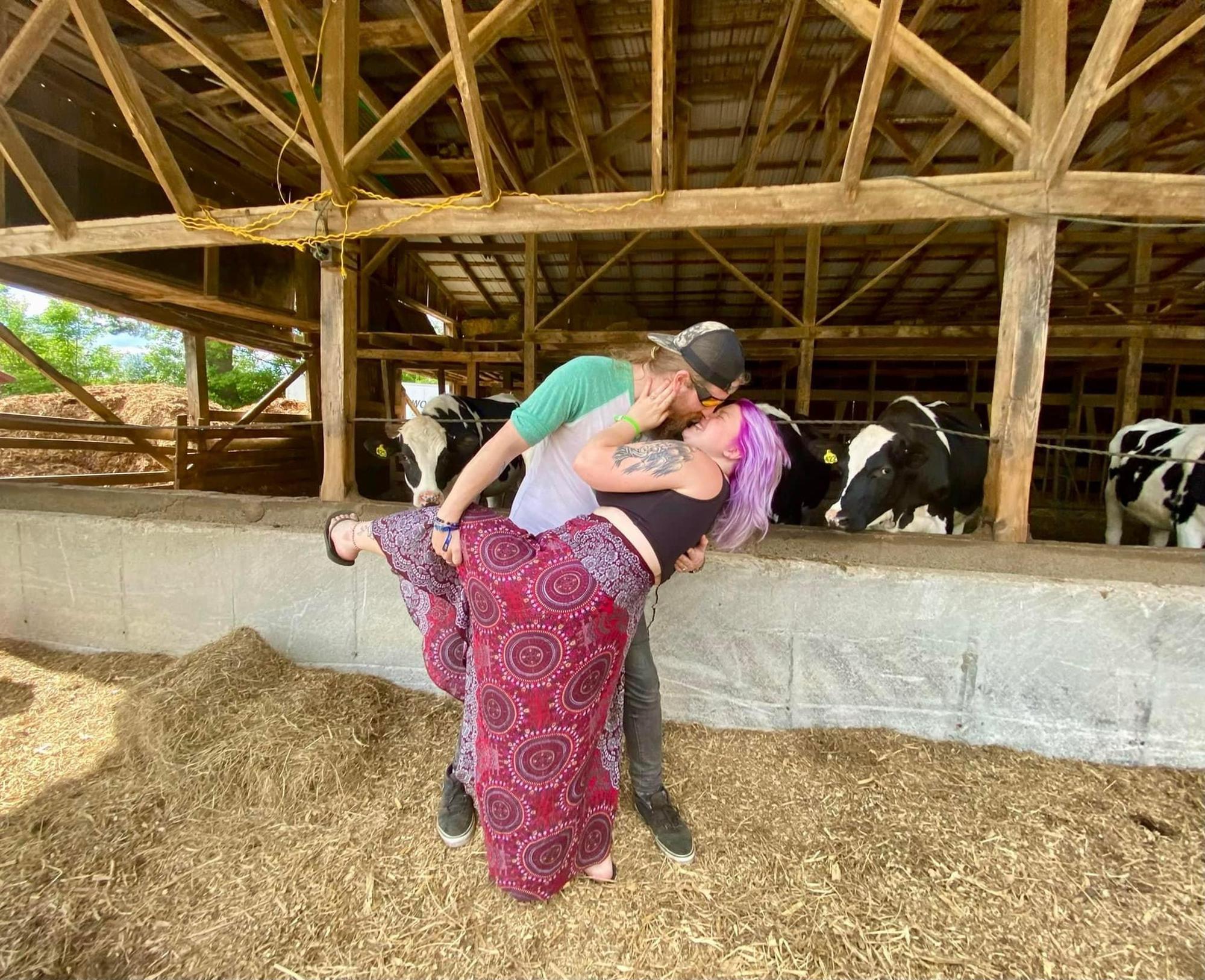 A photo of Christian and Rebecca visiting the cows down the street from their home