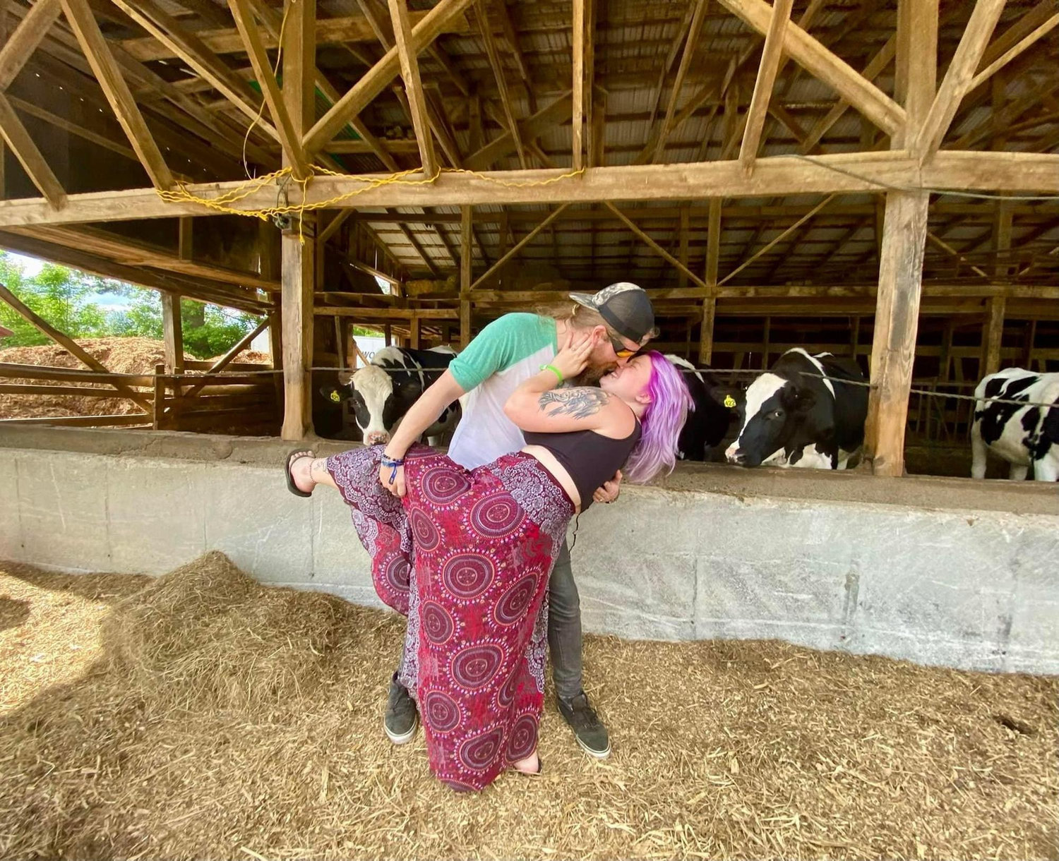 A photo of Christian and Rebecca visiting the cows down the street from their home