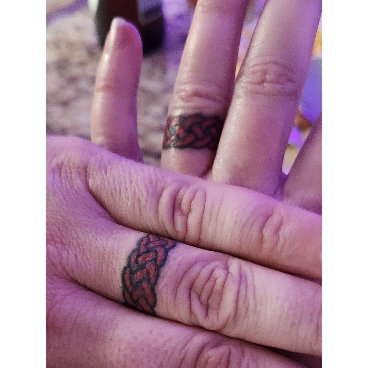 Finger tattoos hurt!  But our wedding ring tattoos are awesome and we love them so much!