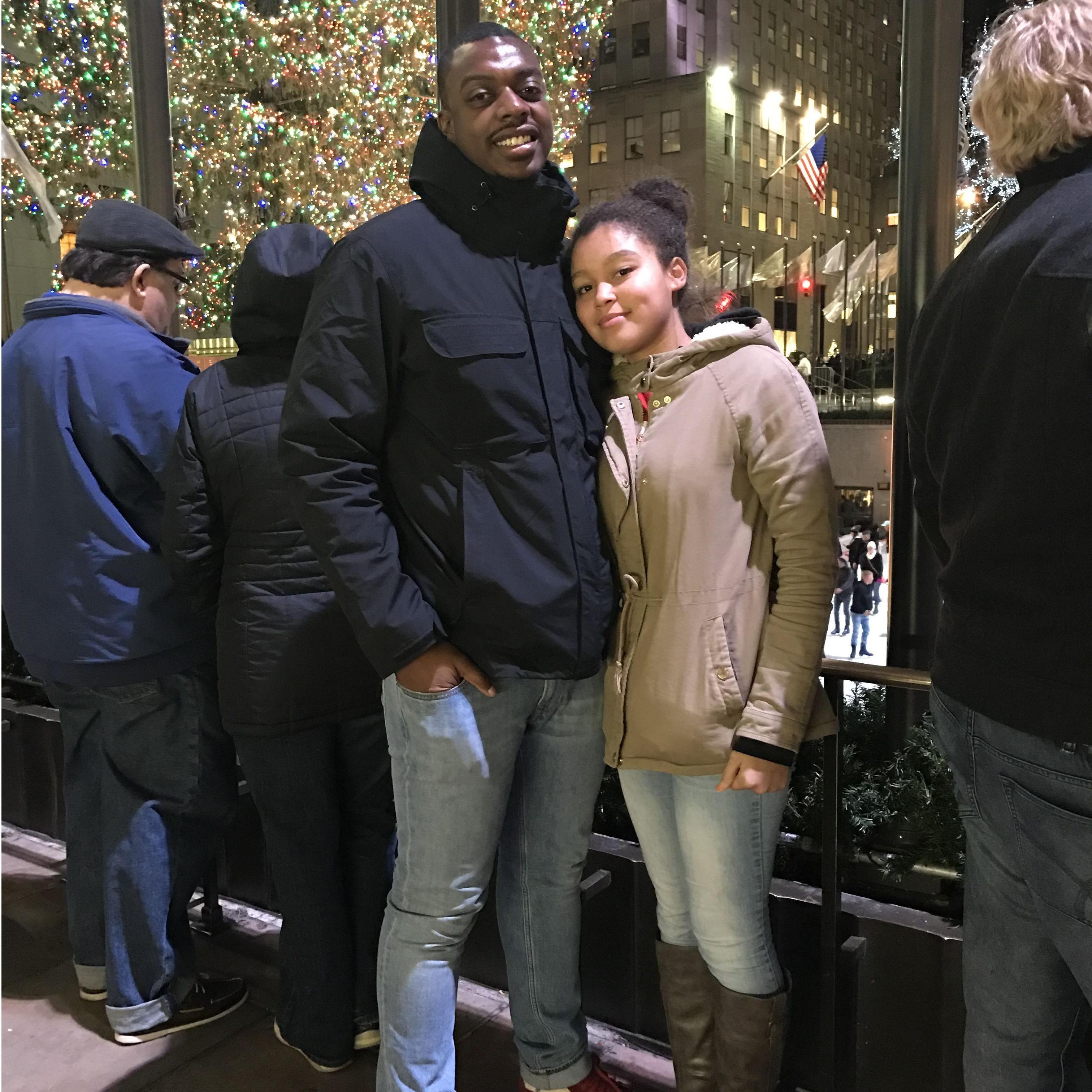 One of our first dates at Rockefeller Center, beaming with early-dating excitement against the festive backdrop of the iconic Christmas tree, aglow with lights.