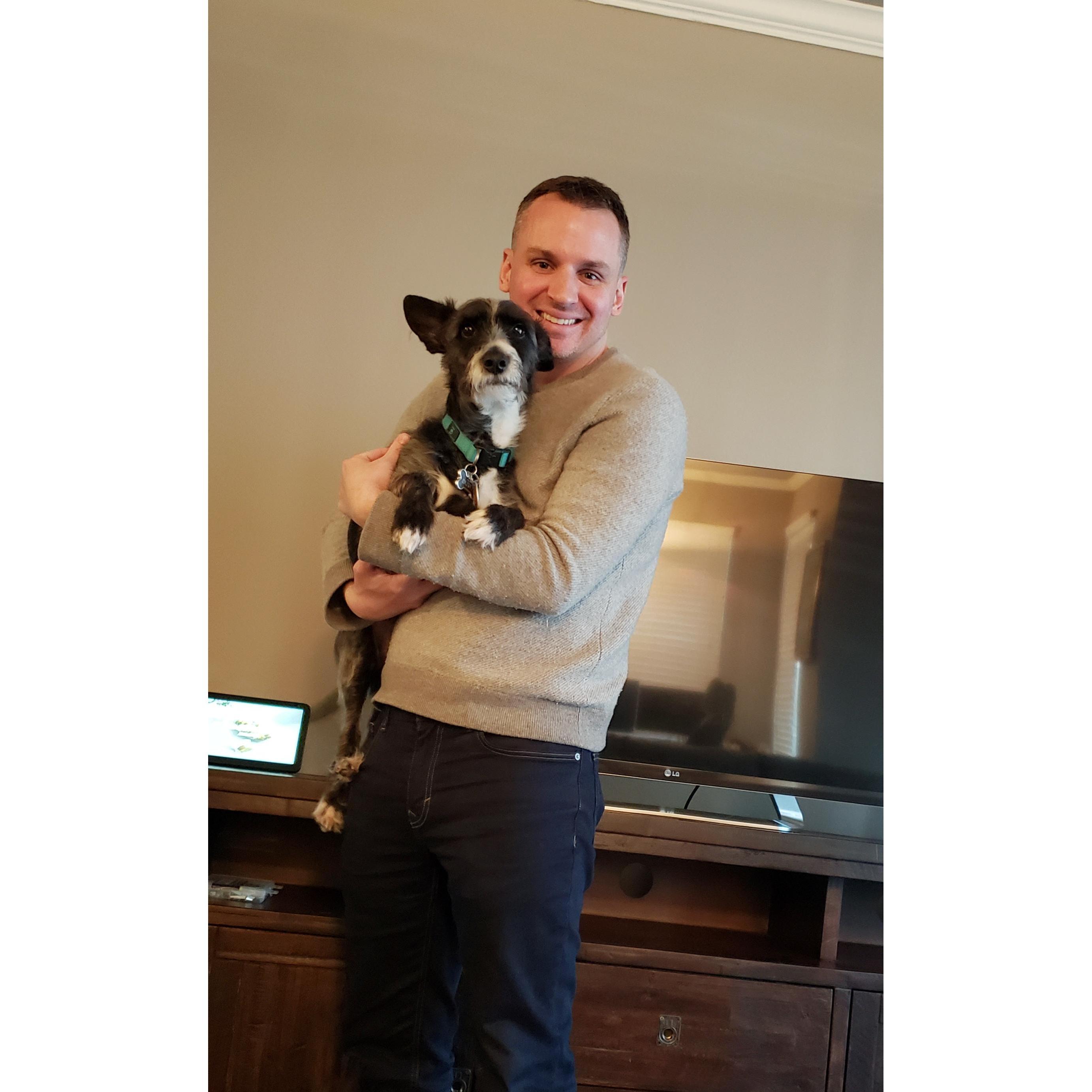 Eric holding his pup Dusty before heading to his parent for our first Christmas together