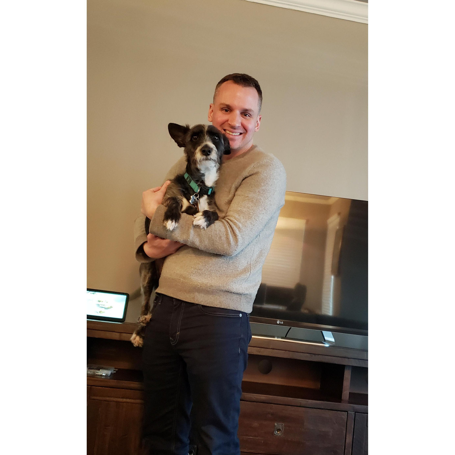 Eric holding his pup Dusty before heading to his parent for our first Christmas together