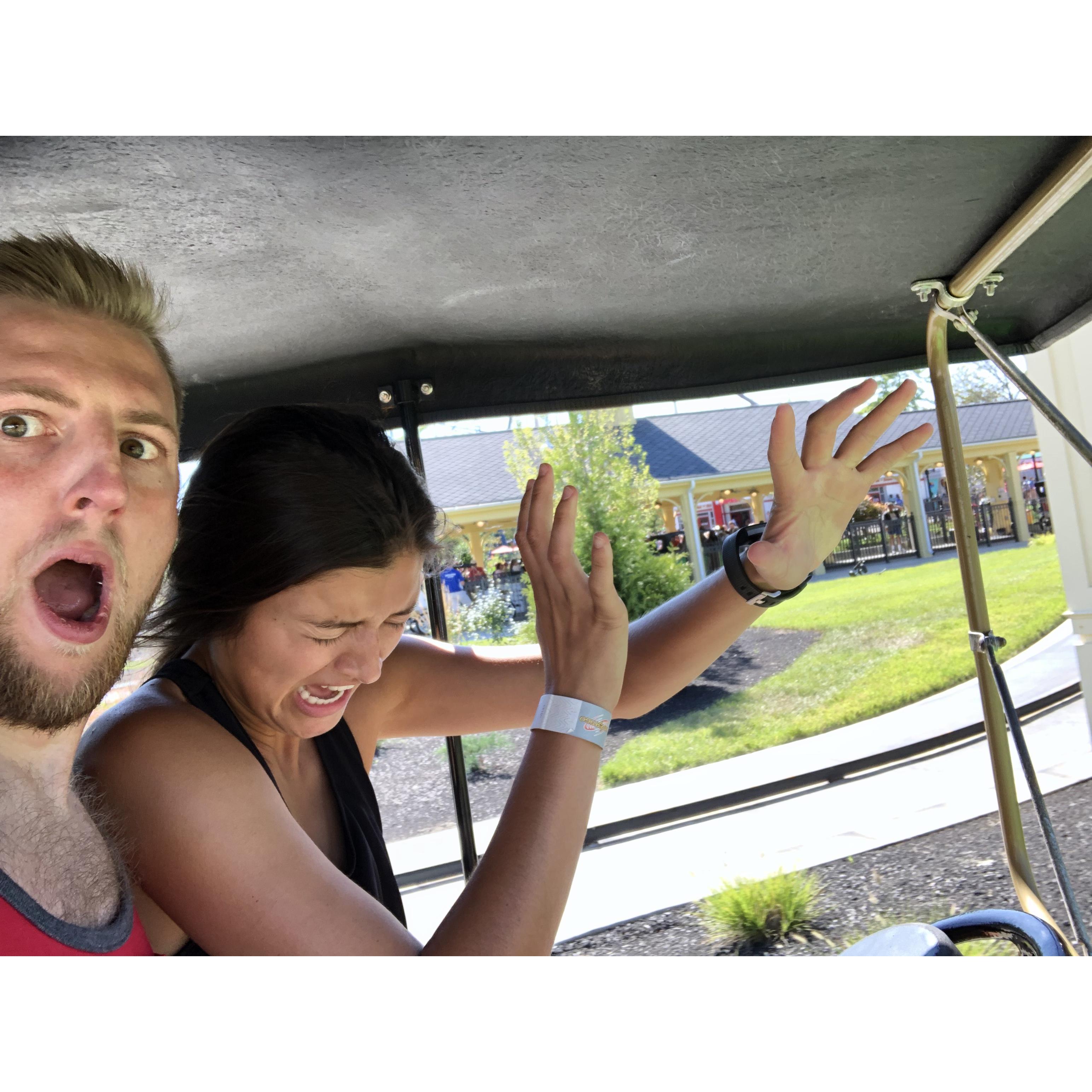 Antique Cars reopened at Kings Island. Anj hasn't driven these cars in decades & we think this picture shows it.
Note: in a real car Anj keeps her eyes on the road and at least a knee on the wheel.