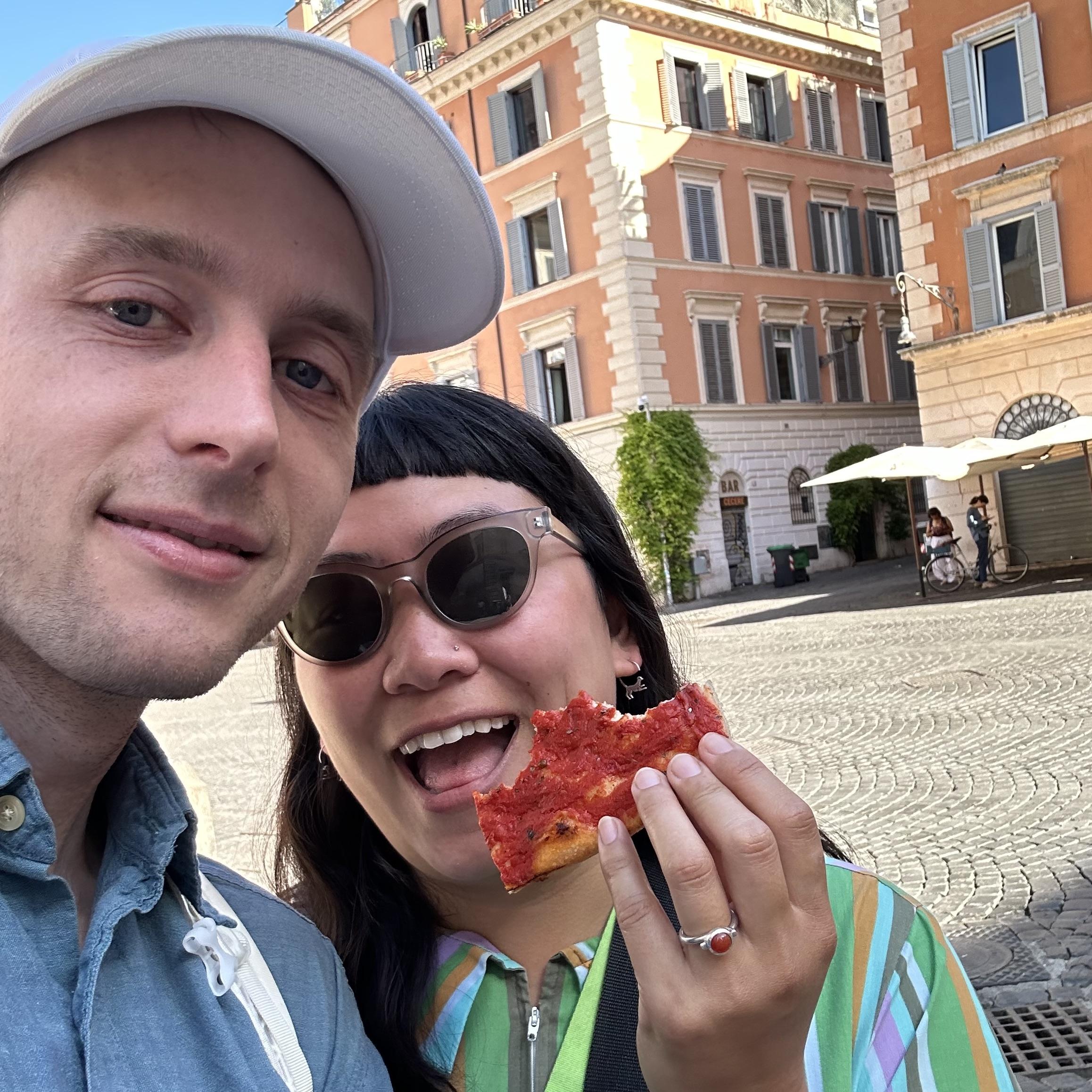 Alex proposed to Elena in Piazza Santa Maria in Trastevere, where Elena lived in 2001. Alex pulled out the ring while Elena was busy unwrapping a piece of Pizza Rossa.