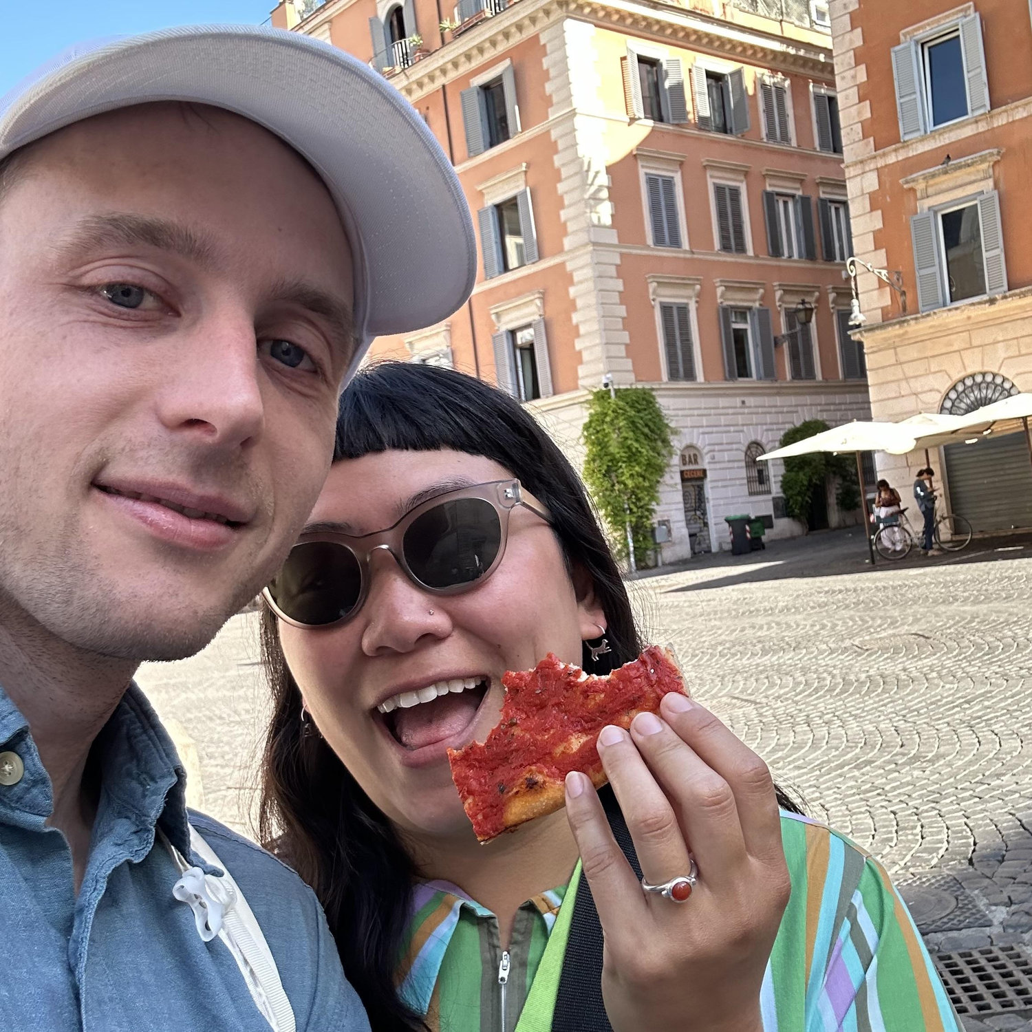 Alex proposed to Elena in Piazza Santa Maria in Trastevere, where Elena lived in 2001. Alex pulled out the ring while Elena was busy unwrapping a piece of Pizza Rossa.
