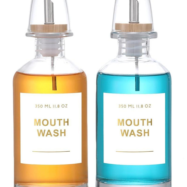 BONLONG 11.8OZ Glass Mouthwash Dispenser for Bathroom with Stainless Steel & Bamboo Nozzle, Mouthwash Cup Reusable, Bamboo Tray, and Elegant Gold Sticker.Set of 2（Clear