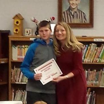 Chris receiving an award at school in 2015. Emily remembers her mom showing her this picture on Facebook then they were dating.