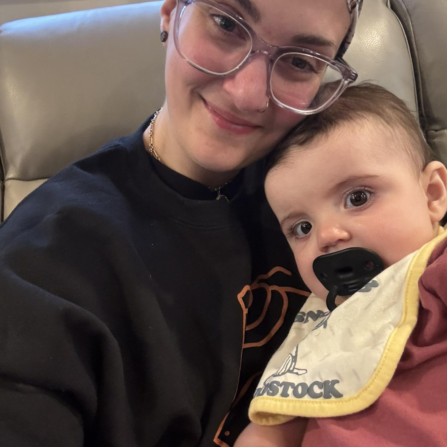 me and my niece aisley wearing the snoopy and woodstock bib i got her. she’s precious.