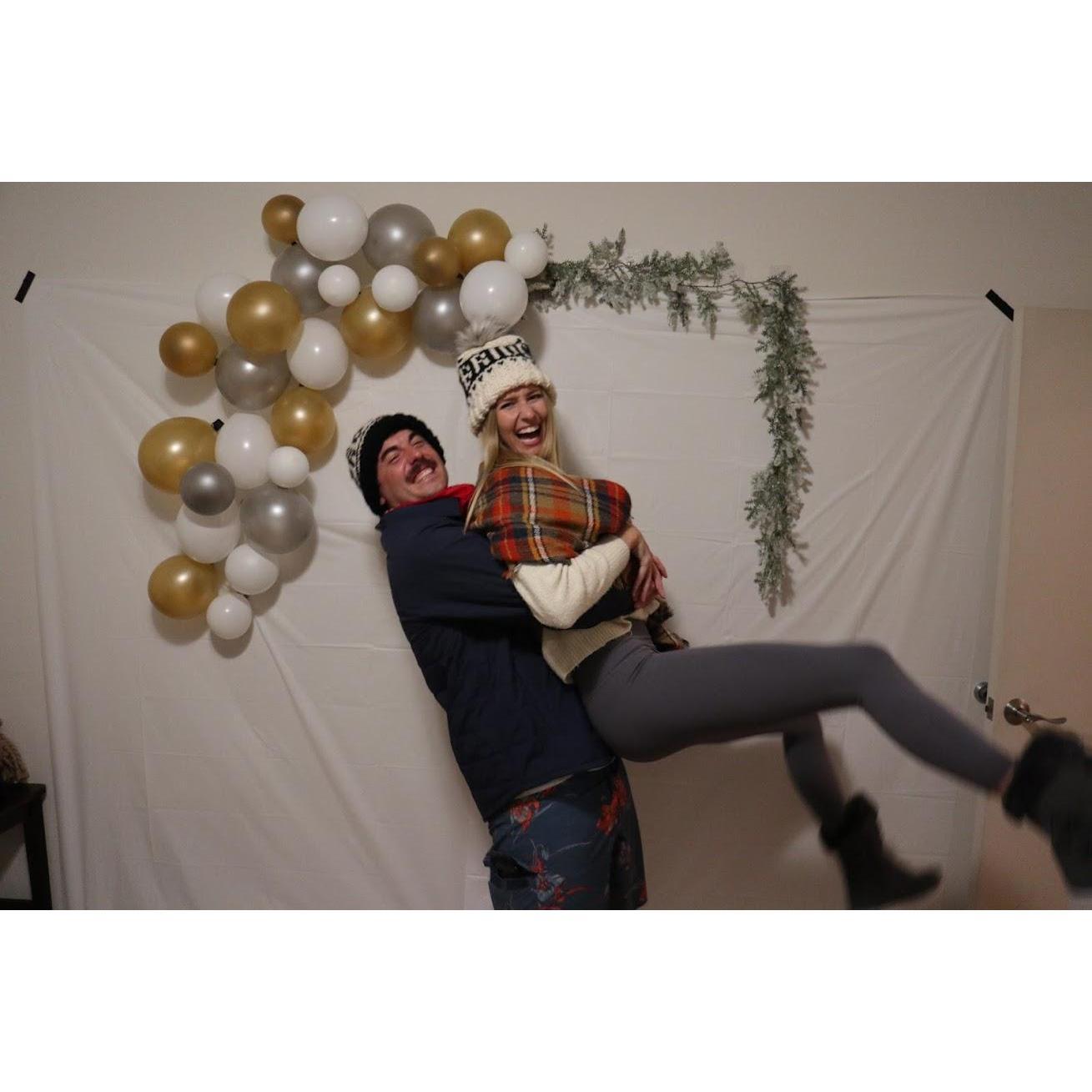 At our Surprise Engagement party thrown by our best friends.