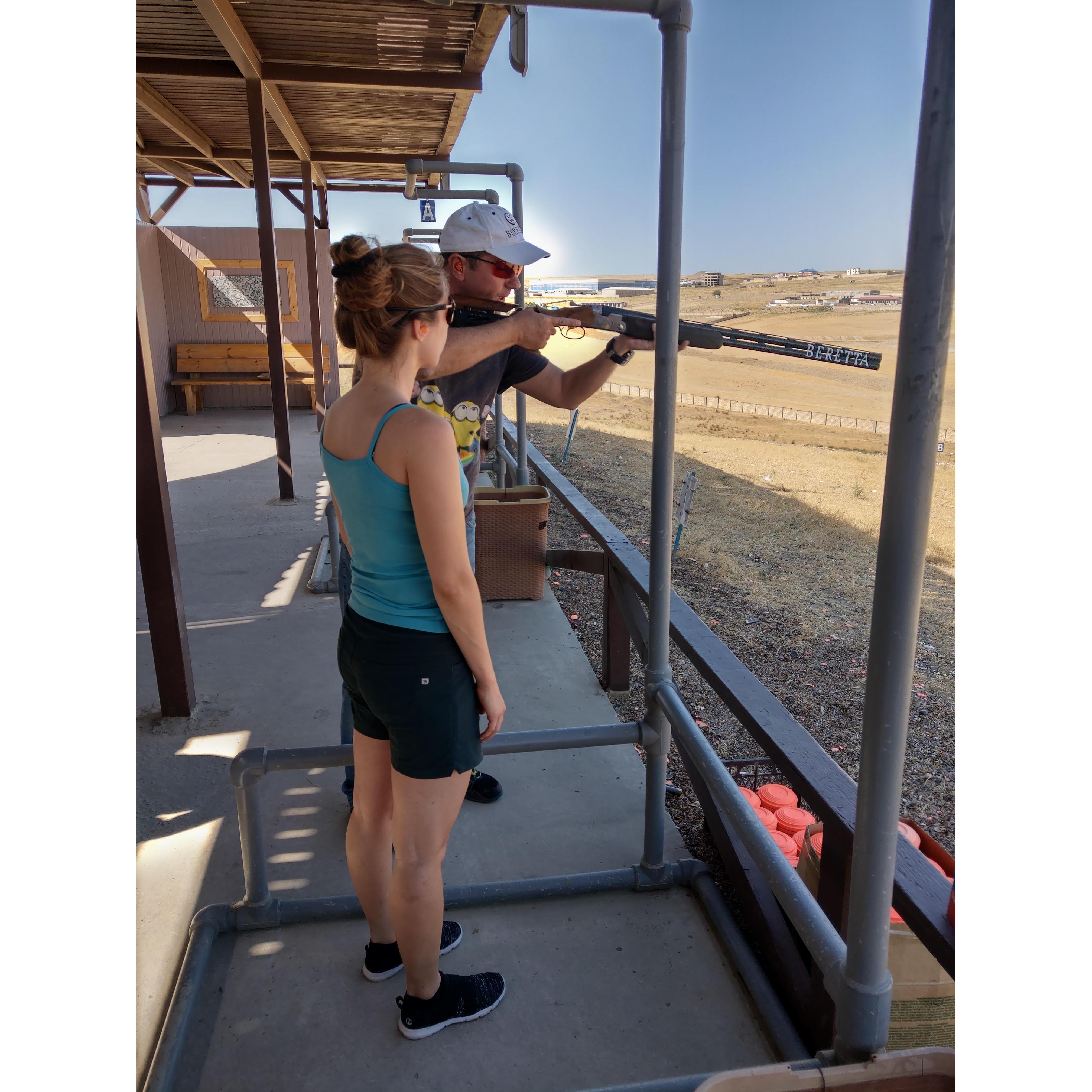 Oleg's father, Andrey, demonstrating to Katya proper posture when shooting clay targets.