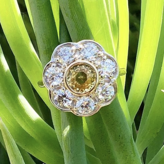 Play the love me / love-me-not game with the diamond "petals" and you will find that the 7th petal affirms our love. The 8th stone ( 8 for infinity ) is a buttery yellow sapphire.